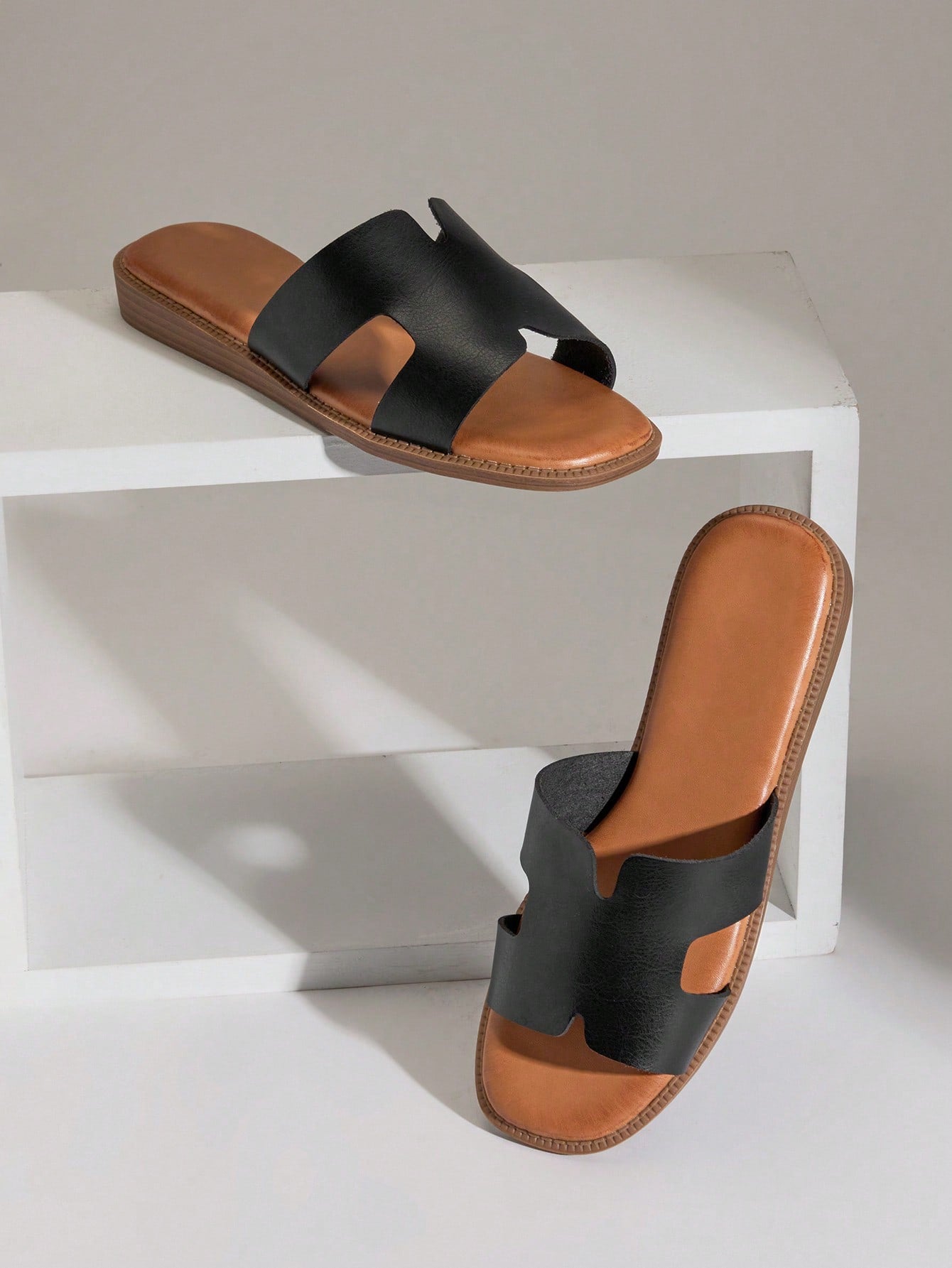 Women's flat slide sandals with supportive PU midsole, harness-style cutout detail, and open toe design.