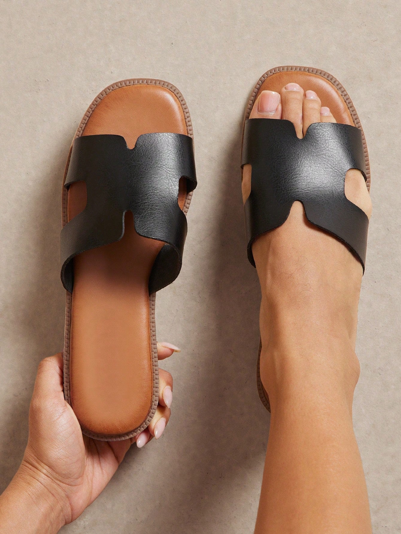Women's flat slide sandals with supportive PU midsole, harness-style cutout detail, and open toe design.