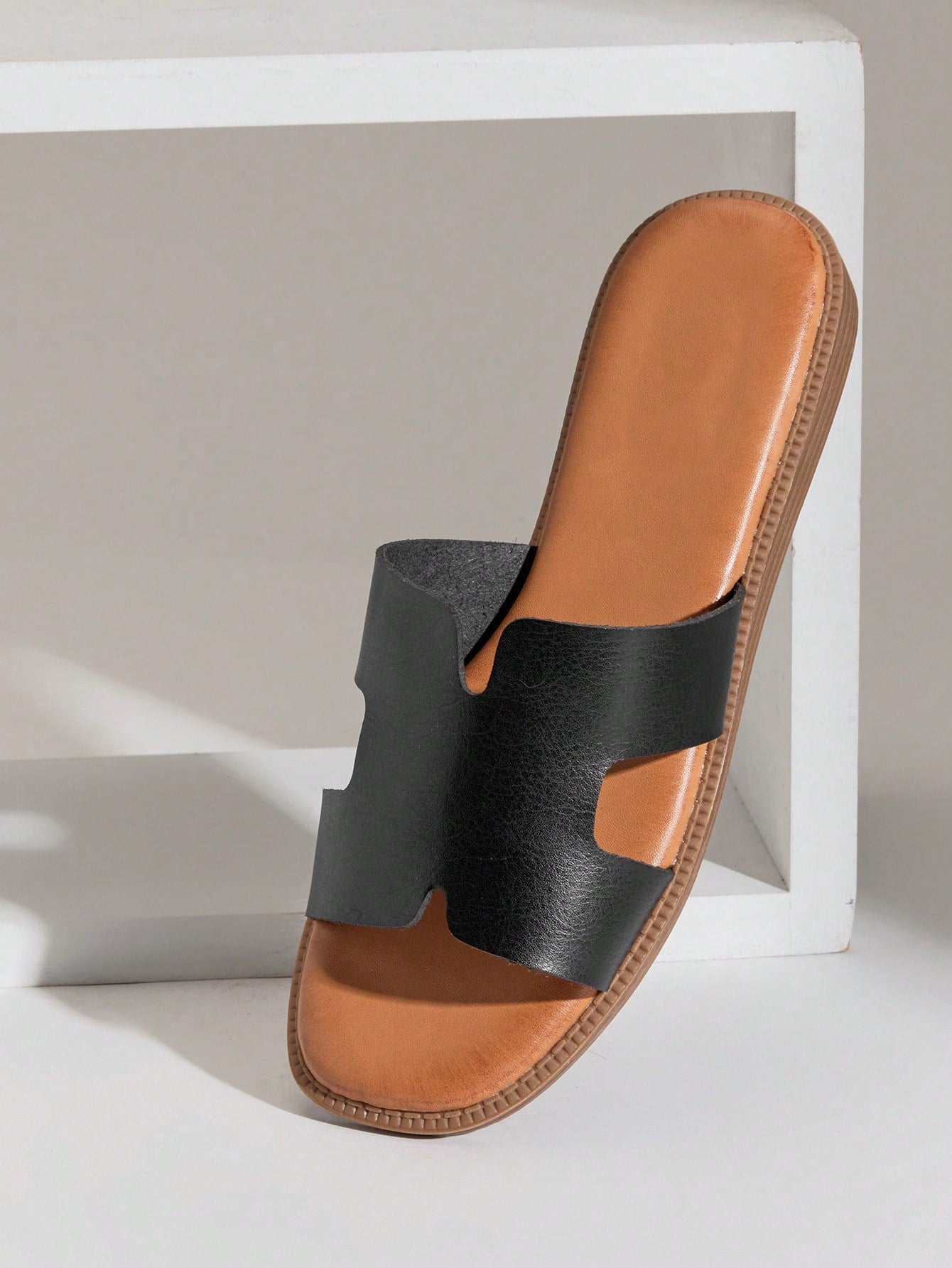 Women's flat slide sandals with supportive PU midsole, harness-style cutout detail, and open toe design.