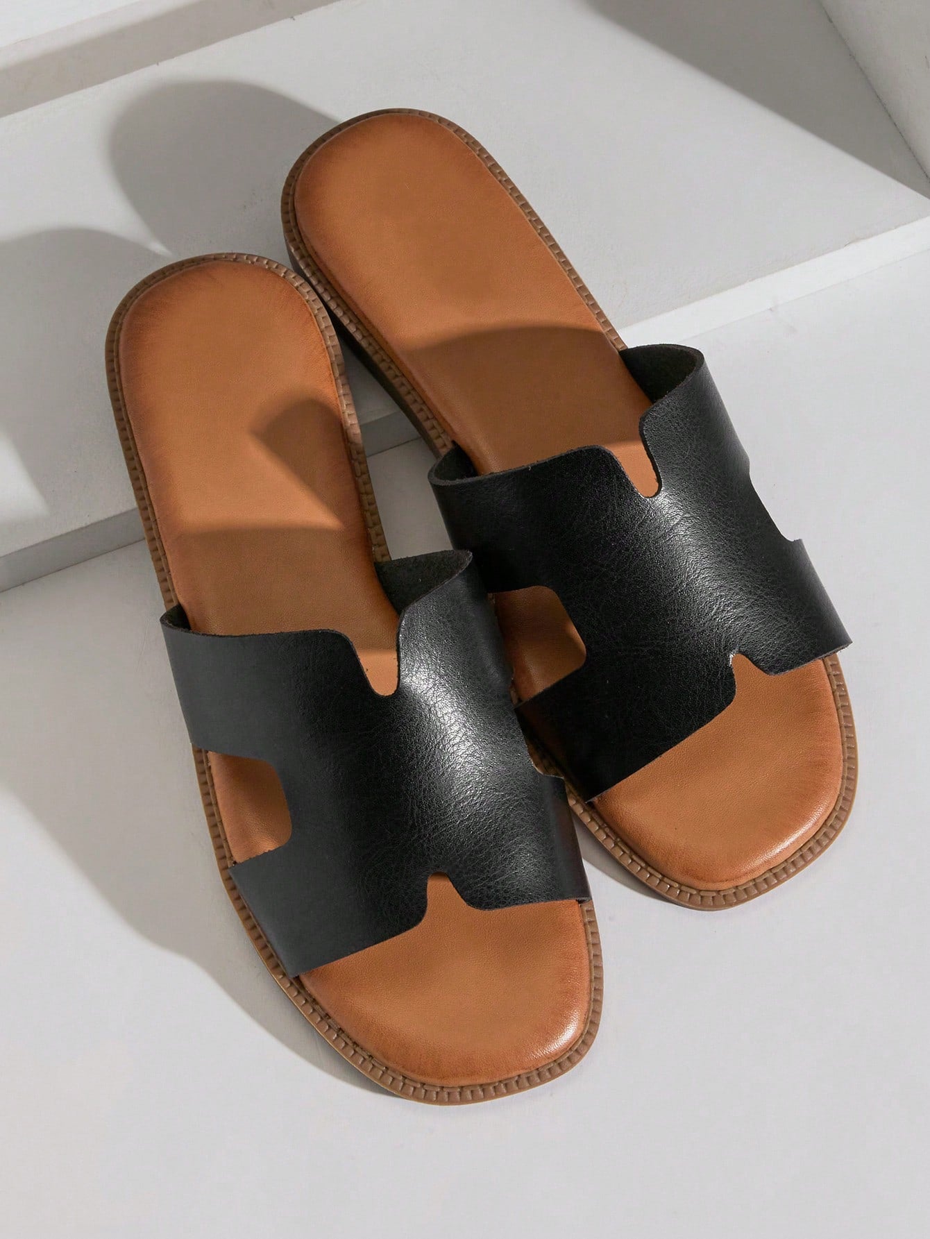 Women's flat slide sandals with supportive PU midsole, harness-style cutout detail, and open toe design.