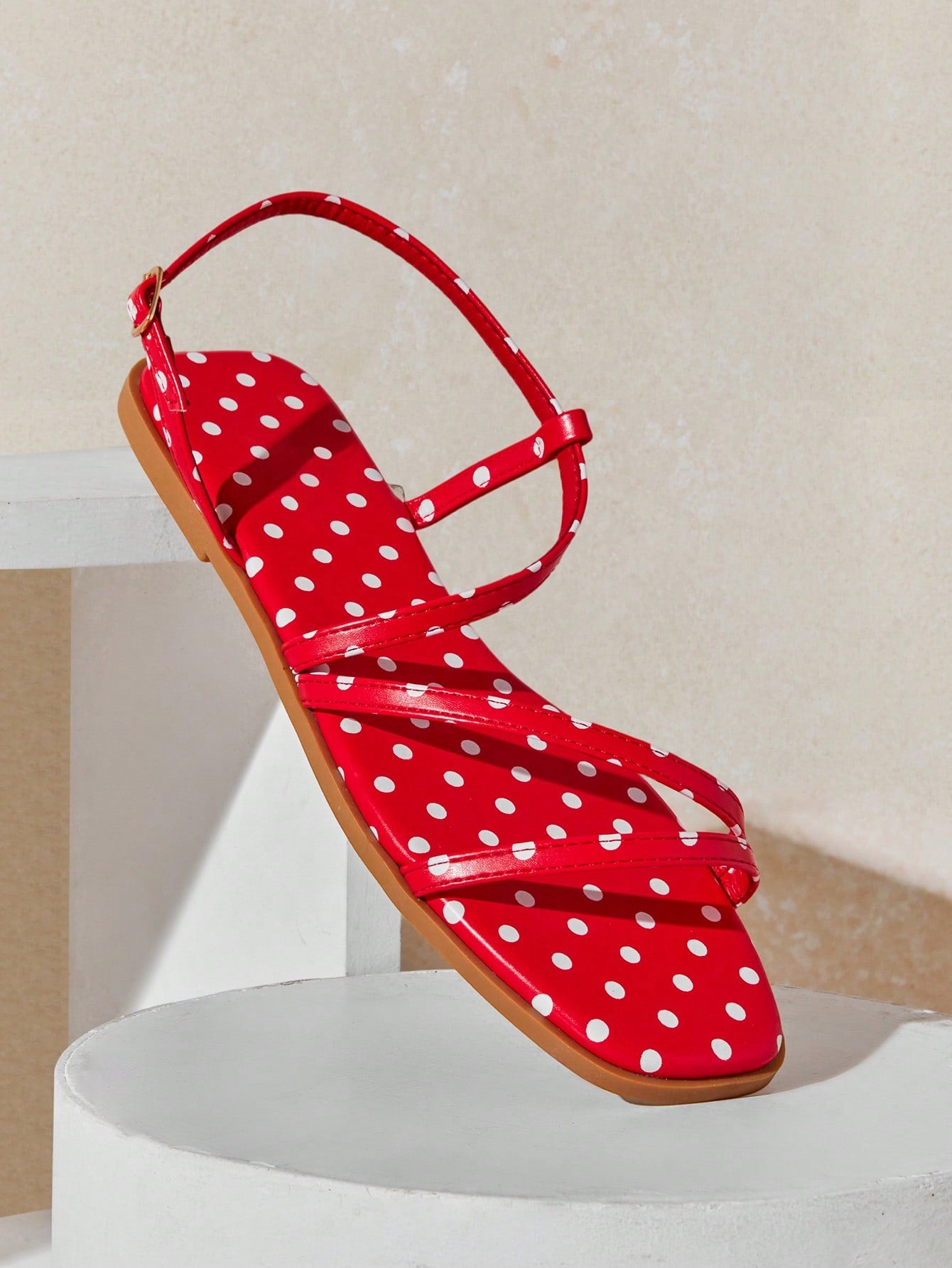 Women's flat open-toe sandals featuring a buckle detail and PU leather construction with a flat sole.