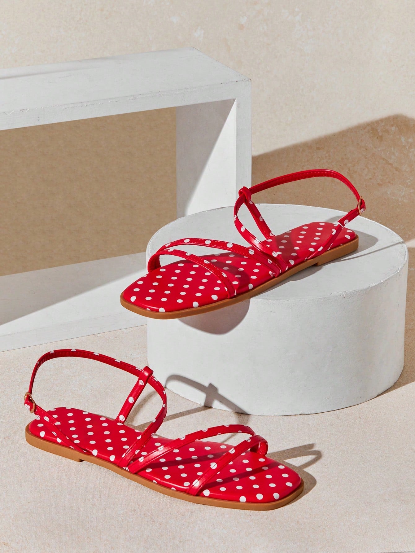 Women's flat open-toe sandals featuring a buckle detail and PU leather construction with a flat sole.
