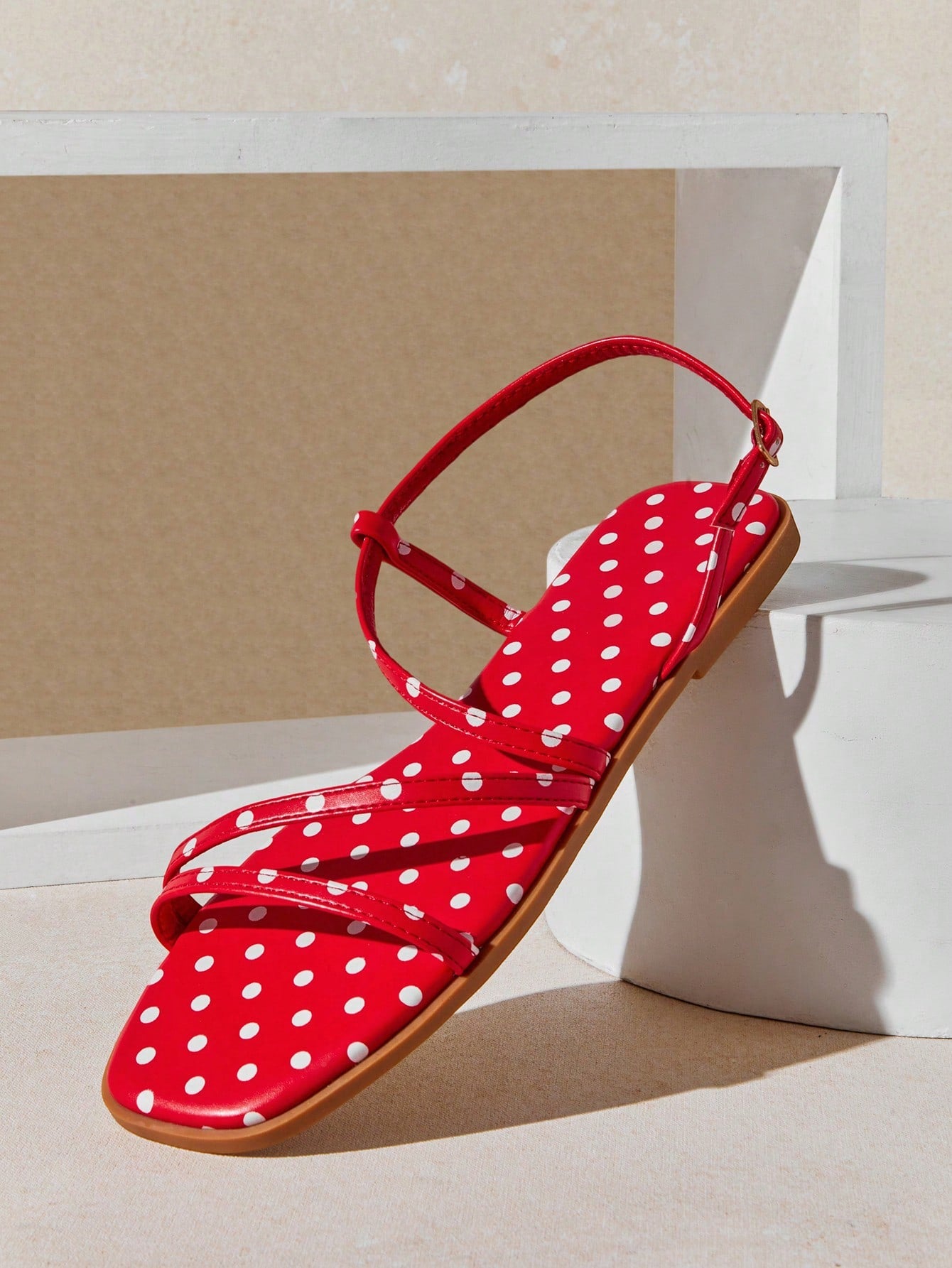 Women's flat open-toe sandals featuring a buckle detail and PU leather construction with a flat sole.