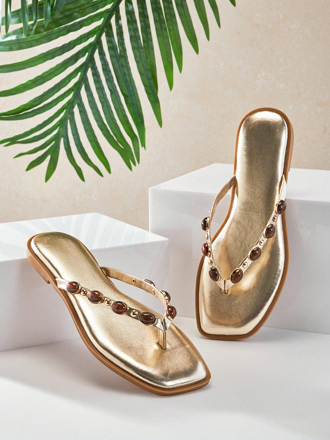 Women's gold metallic PU flip-flop thong sandals with square toe, toe-post front, and tiger eye gemstone decor with turquoise texture detail.