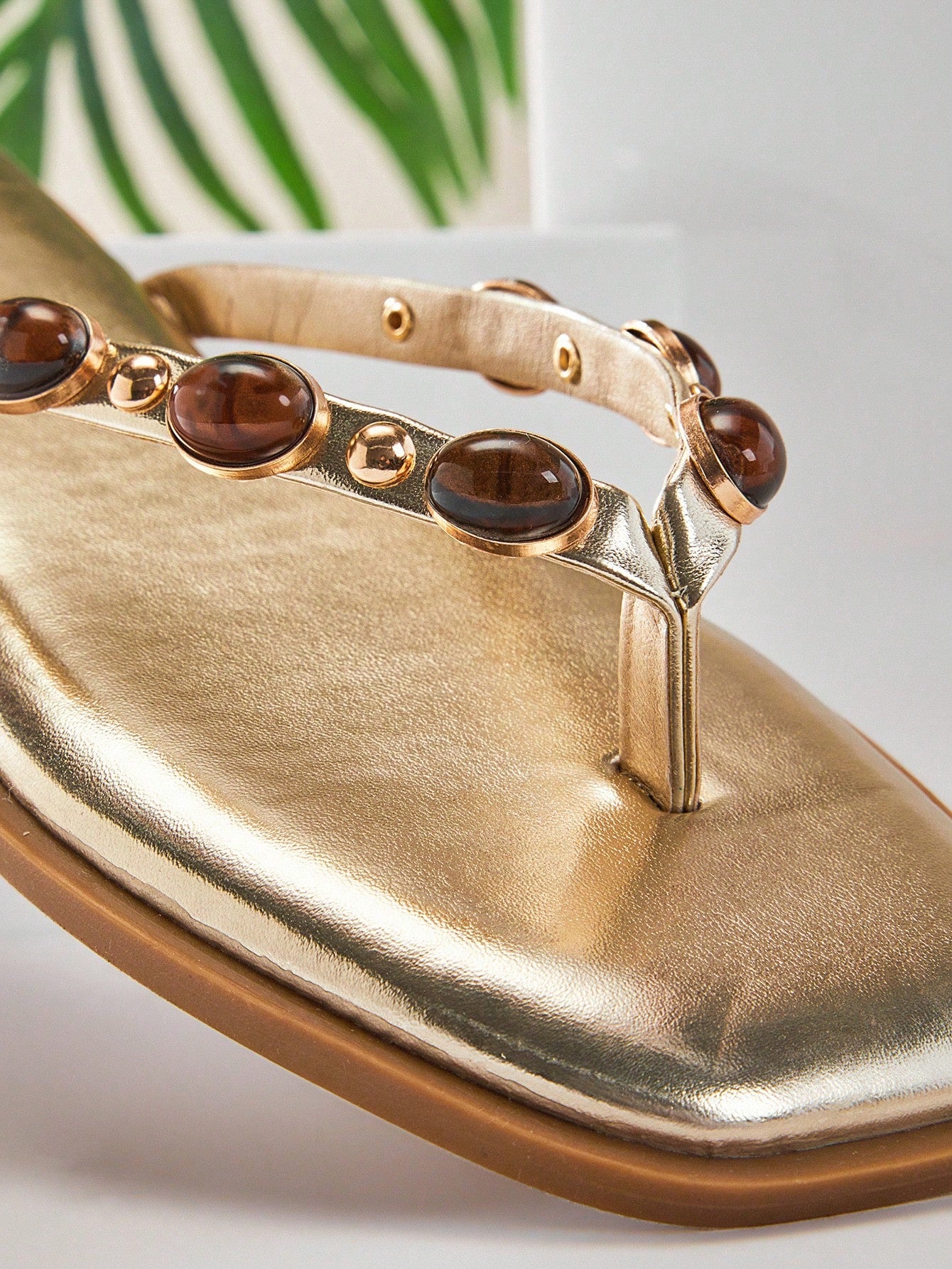 Women's gold metallic PU flip-flop thong sandals with square toe, toe-post front, and tiger eye gemstone decor with turquoise texture detail.