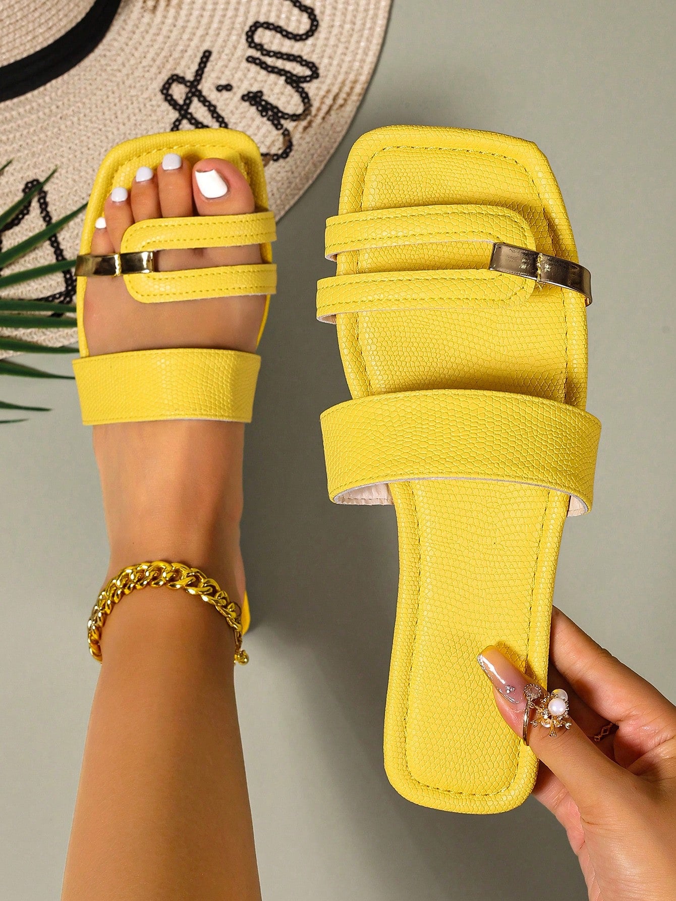 Women's yellow open-toe flat slide sandals featuring a cut-out design and textured plain pattern for casual beach and daily wear.