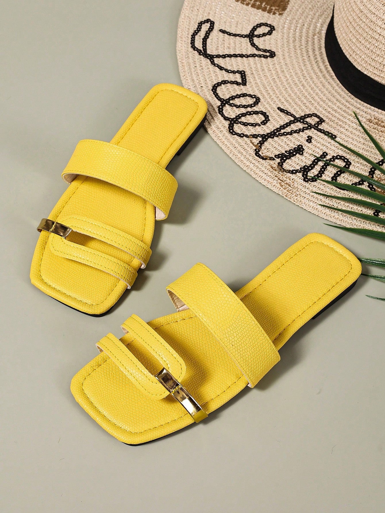 Women's yellow open-toe flat slide sandals featuring a cut-out design and textured plain pattern for casual beach and daily wear.