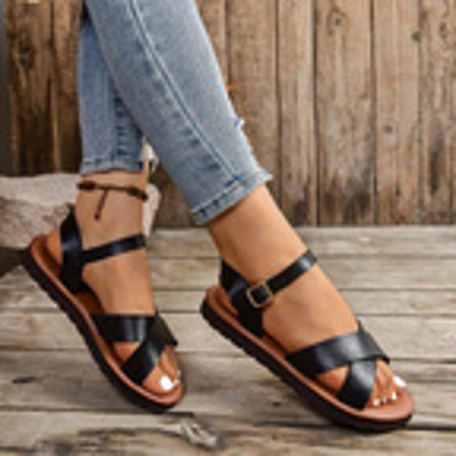 Women's plus size flat gladiator sandals with cross straps, cut-out details, and open toe in a casual retro Roman style for beach and everyday wear.