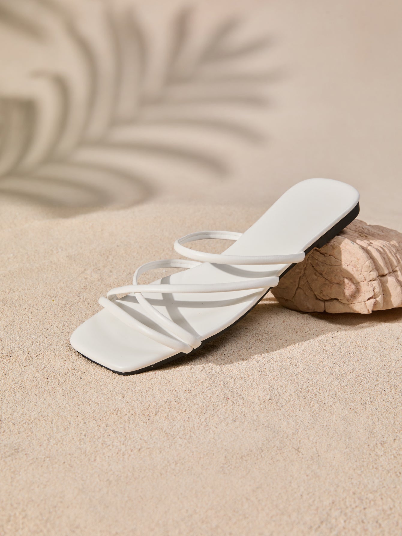 Women's white flat gladiator sandals with square toe, criss-cross straps, and toe post detail