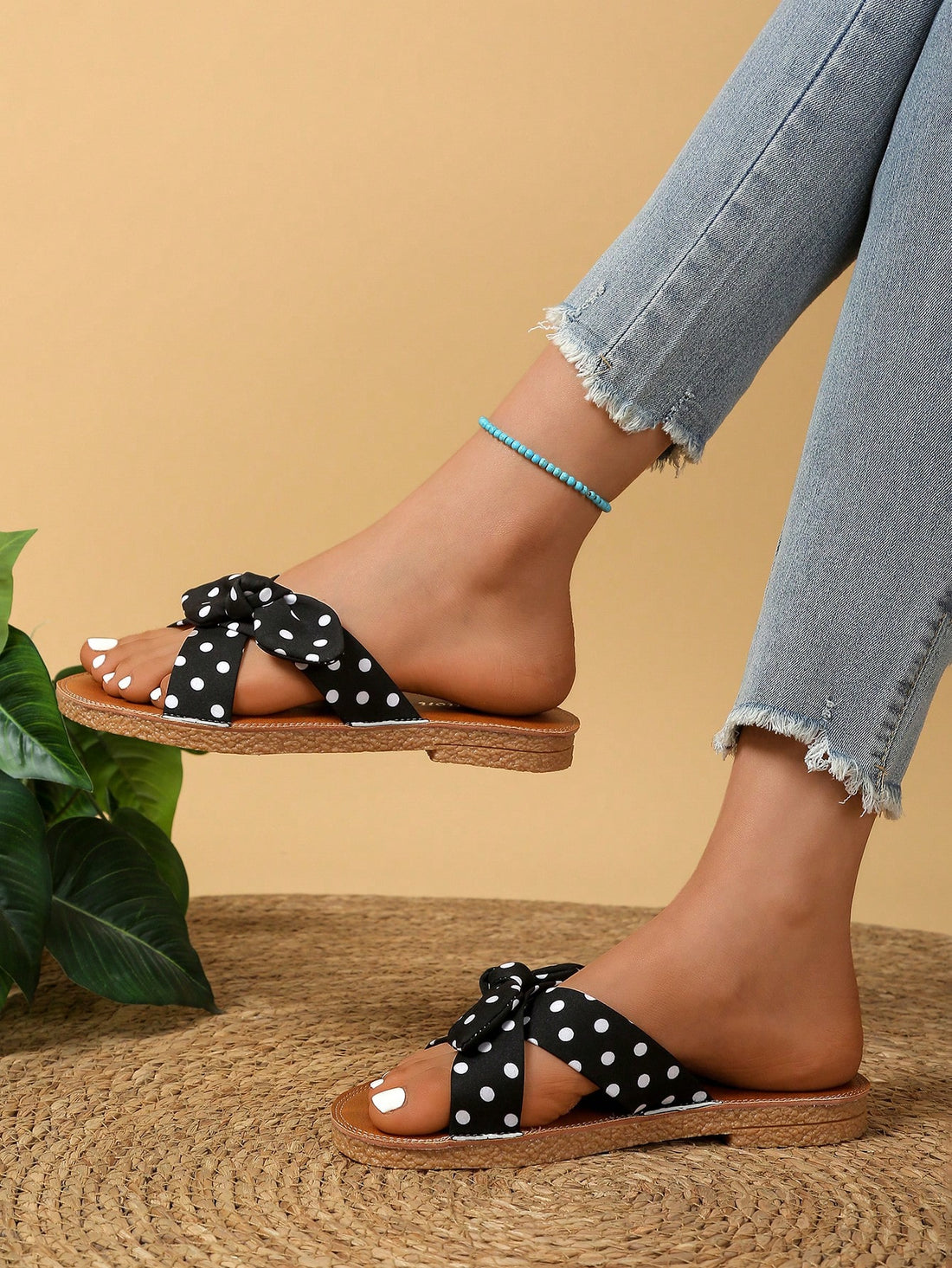 Black women’s flat slide sandals with bow detail, geometric pattern, open toe, fabric upper, PU leather lining and insole, and rubber non-slip outsole for beach wear.
