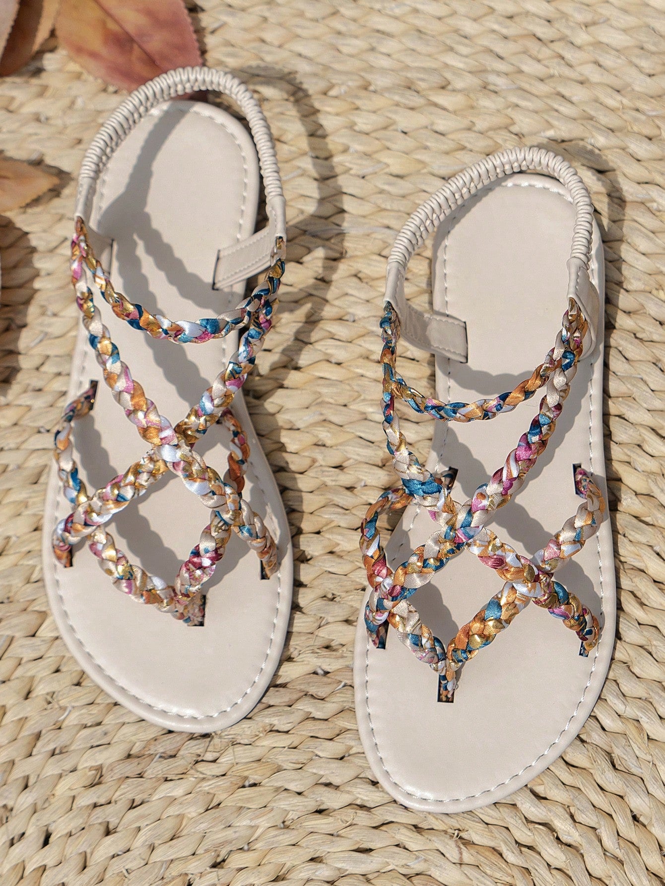 Women’s leopard print woven strap Roman-style flat slide sandals with toe post and cut-out detail.