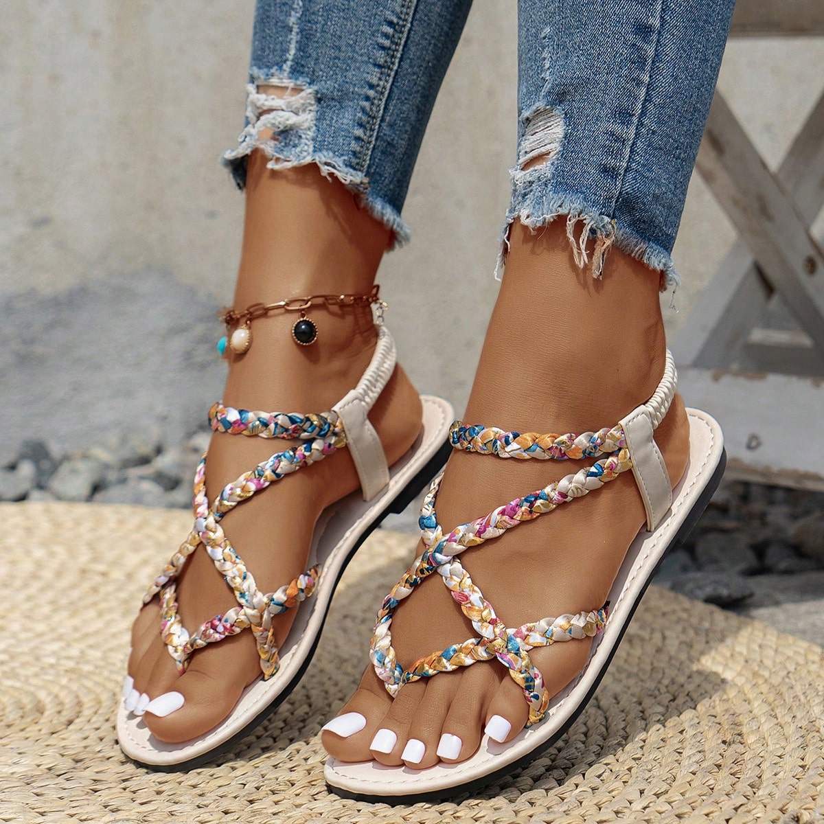 Women’s leopard print woven strap Roman-style flat slide sandals with toe post and cut-out detail.