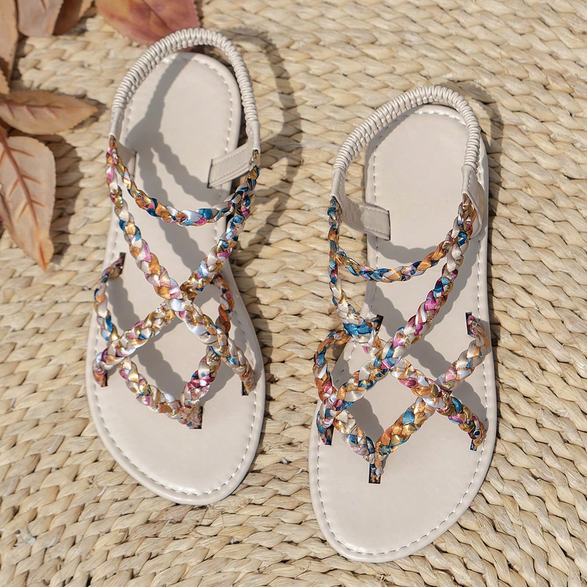 Women’s leopard print woven strap Roman-style flat slide sandals with toe post and cut-out detail.