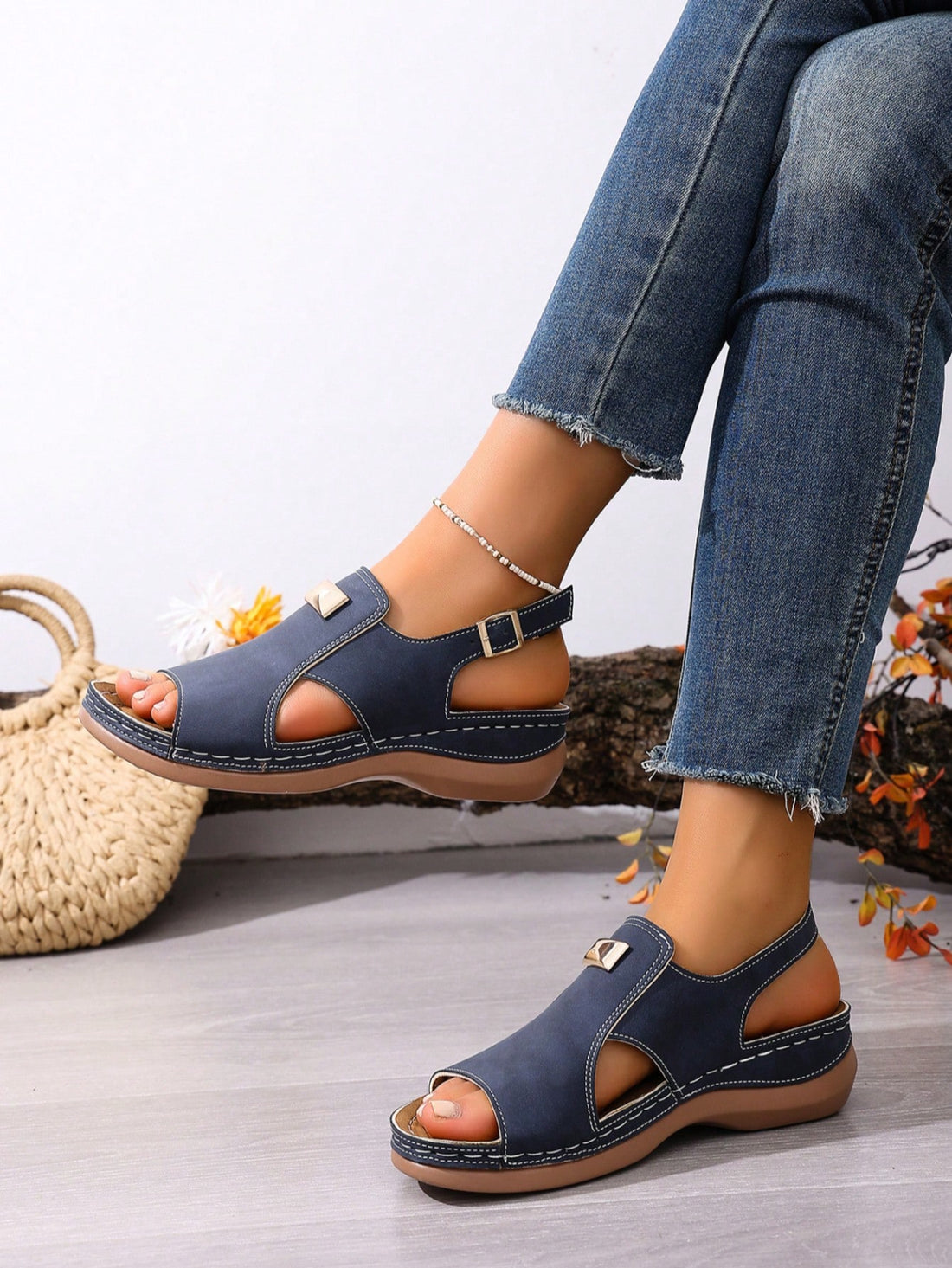 Women's navy blue open-toe wedge sandals with hollow-out design and buckle closure, mid heel, and casual outdoor style.