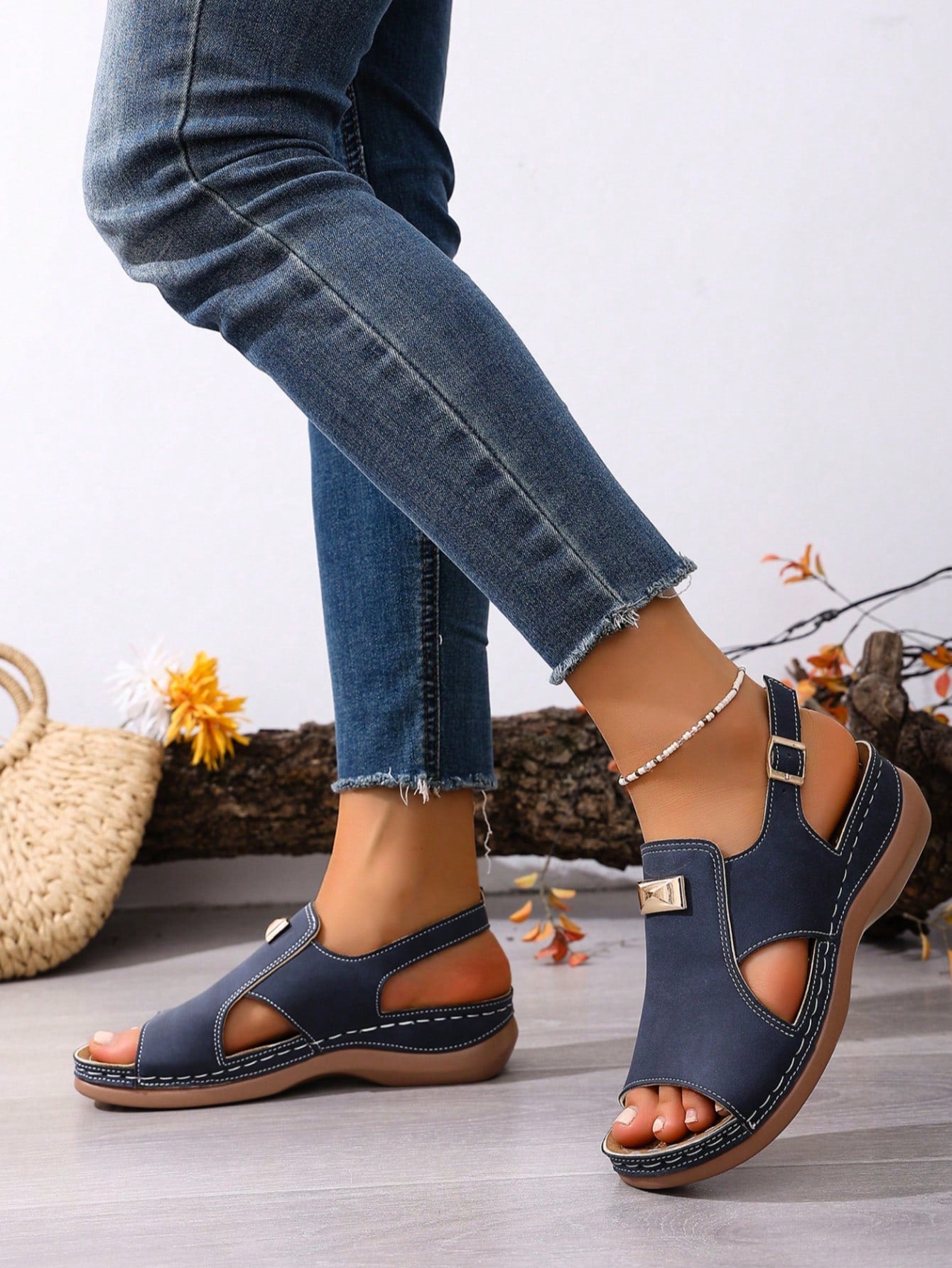 Women's navy blue open-toe wedge sandals with hollow-out design and buckle closure, mid heel, and casual outdoor style.