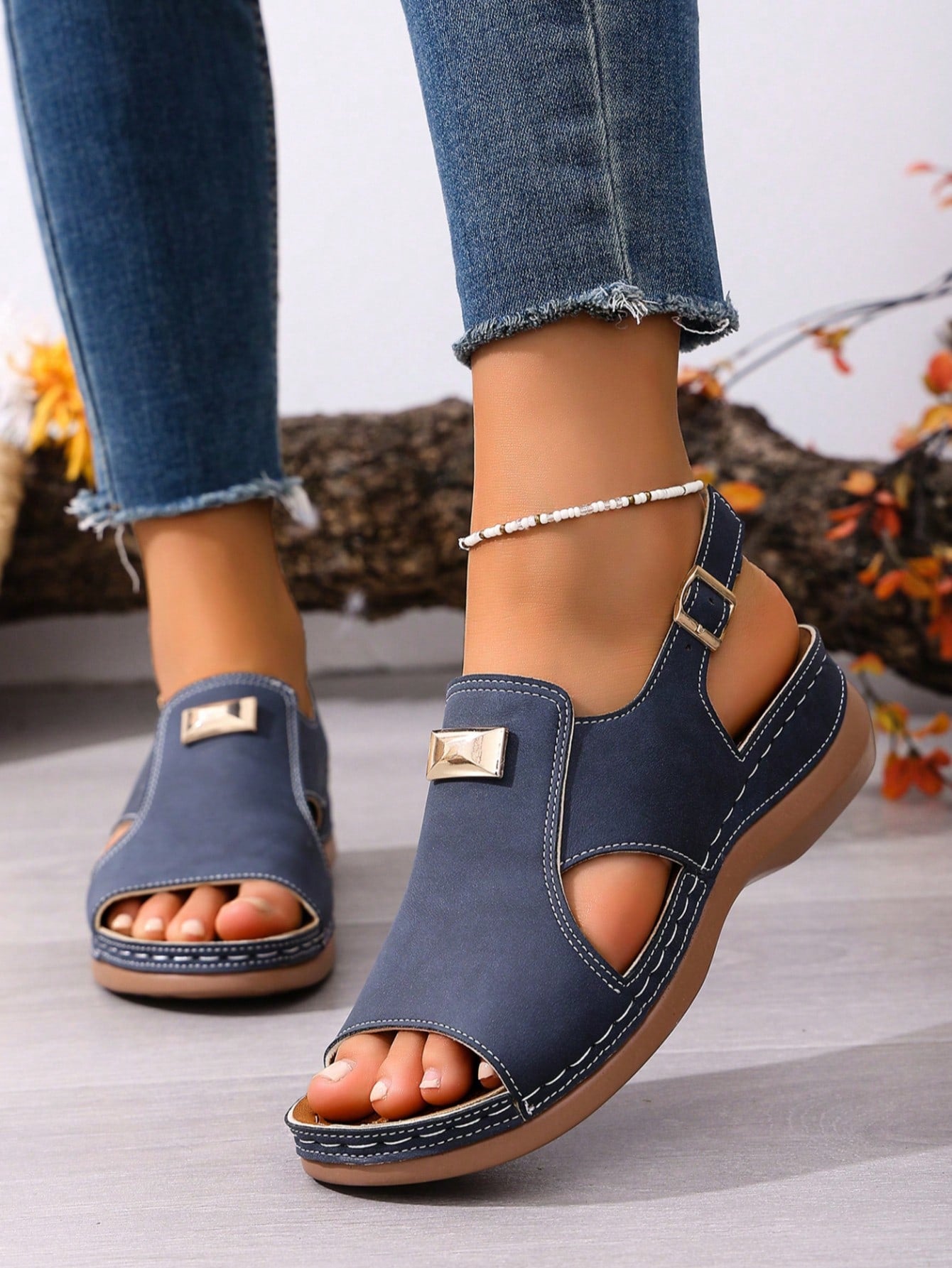 Women's navy blue open-toe wedge sandals with hollow-out design and buckle closure, mid heel, and casual outdoor style.