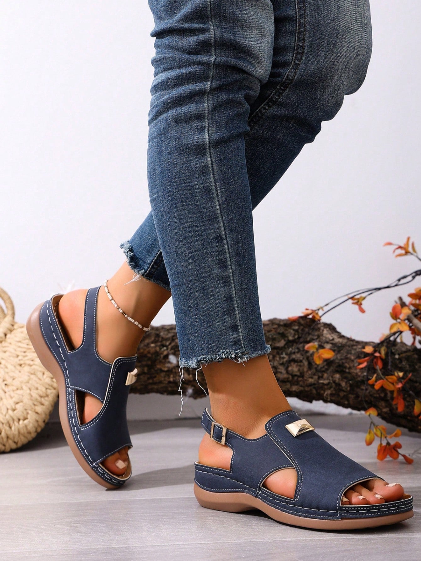 Women's navy blue open-toe wedge sandals with hollow-out design and buckle closure, mid heel, and casual outdoor style.