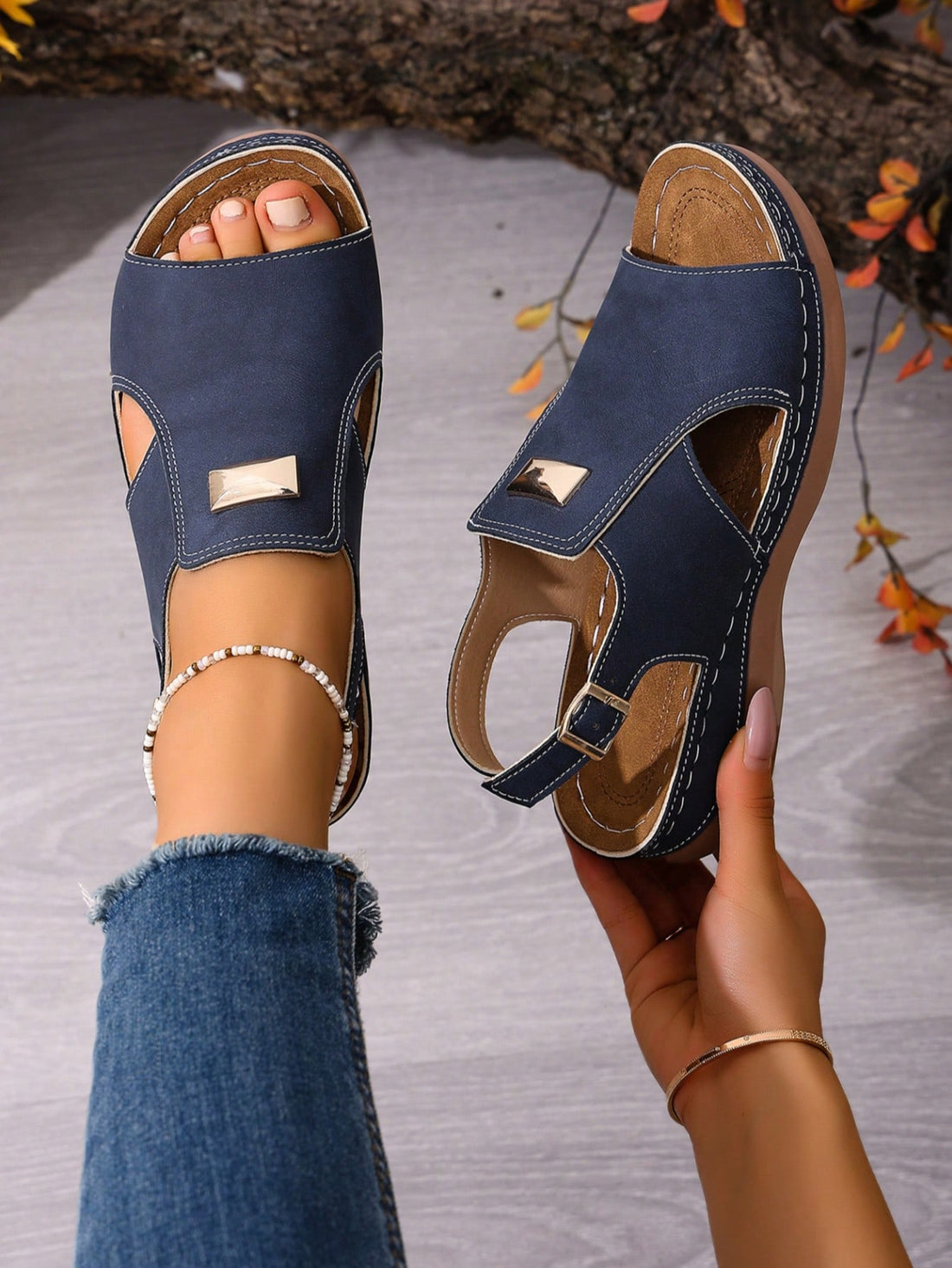 Women's navy blue open-toe wedge sandals with hollow-out design and buckle closure, mid heel, and casual outdoor style.