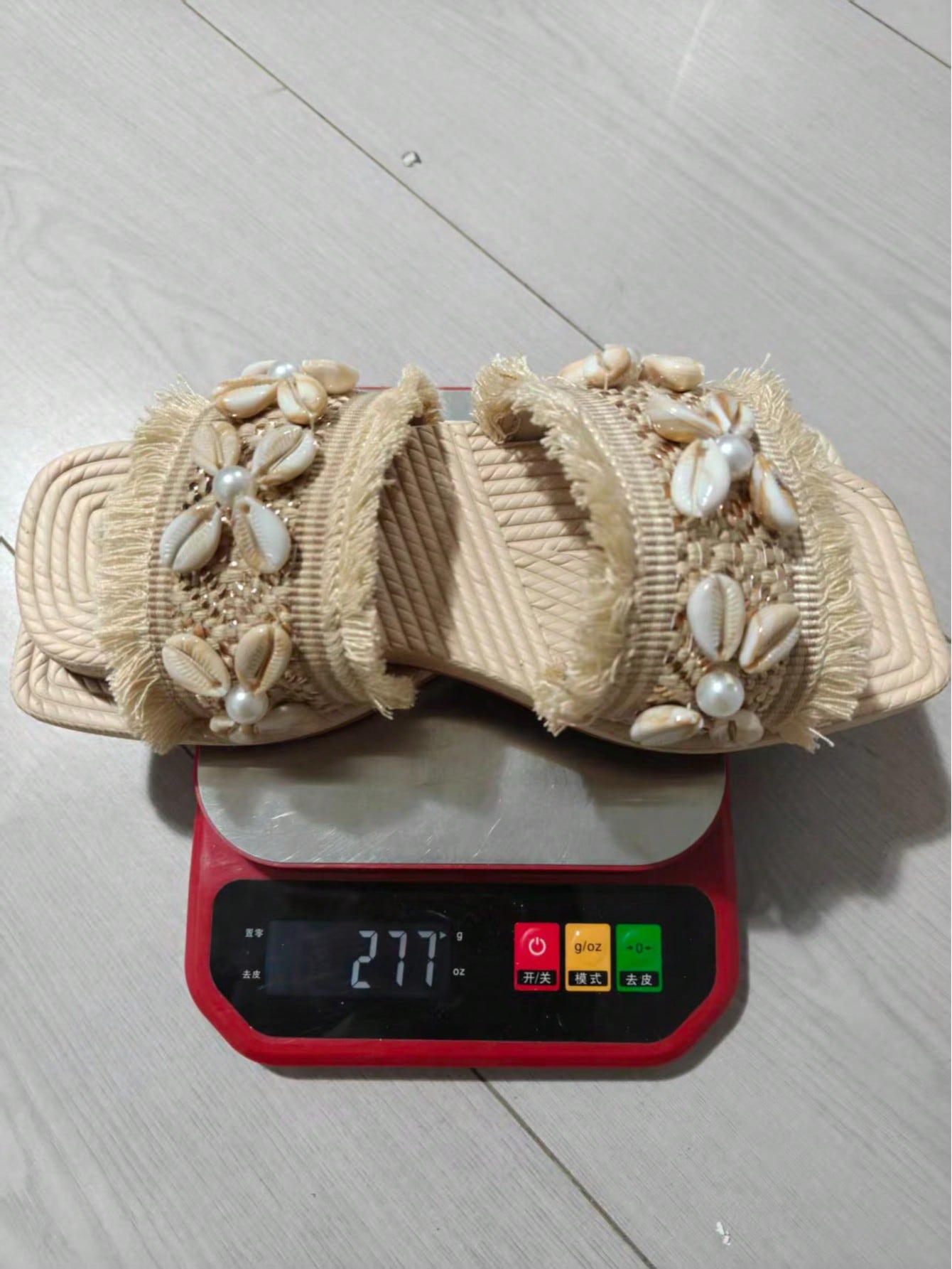 Women's open-toe strappy flat sandals with tasseled upper, seashell-inspired decoration, and rhinestone detail, designed for lightweight, comfortable beach and casual indoor or outdoor wear.