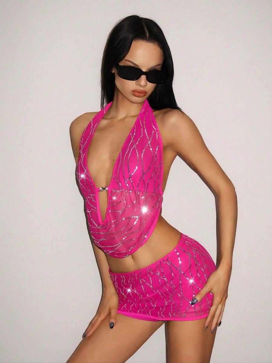 Sparkly sequin halter crop top and bodycon mini skirt two-piece party set with tassel details, backless knot design, and arm sleeves