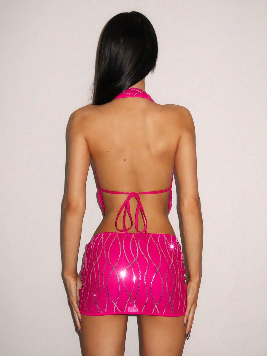 Sparkly sequin halter crop top and bodycon mini skirt two-piece party set with tassel details, backless knot design, and arm sleeves