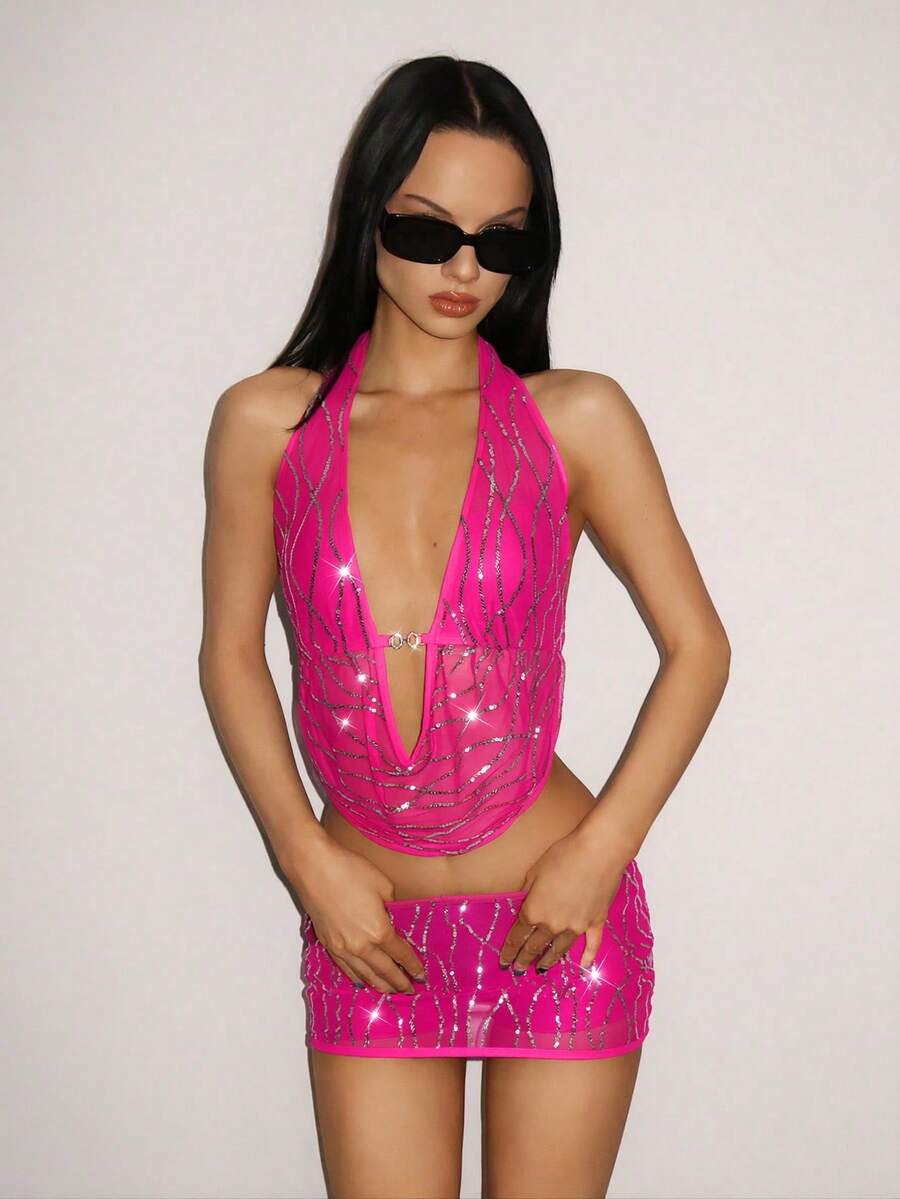 Sparkly sequin halter crop top and bodycon mini skirt two-piece party set with tassel details, backless knot design, and arm sleeves