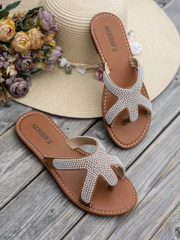 Women's brown flat thong sandals with starfish and pearl detail, criss-cross straps, and toe post design for beach casual summer wear.