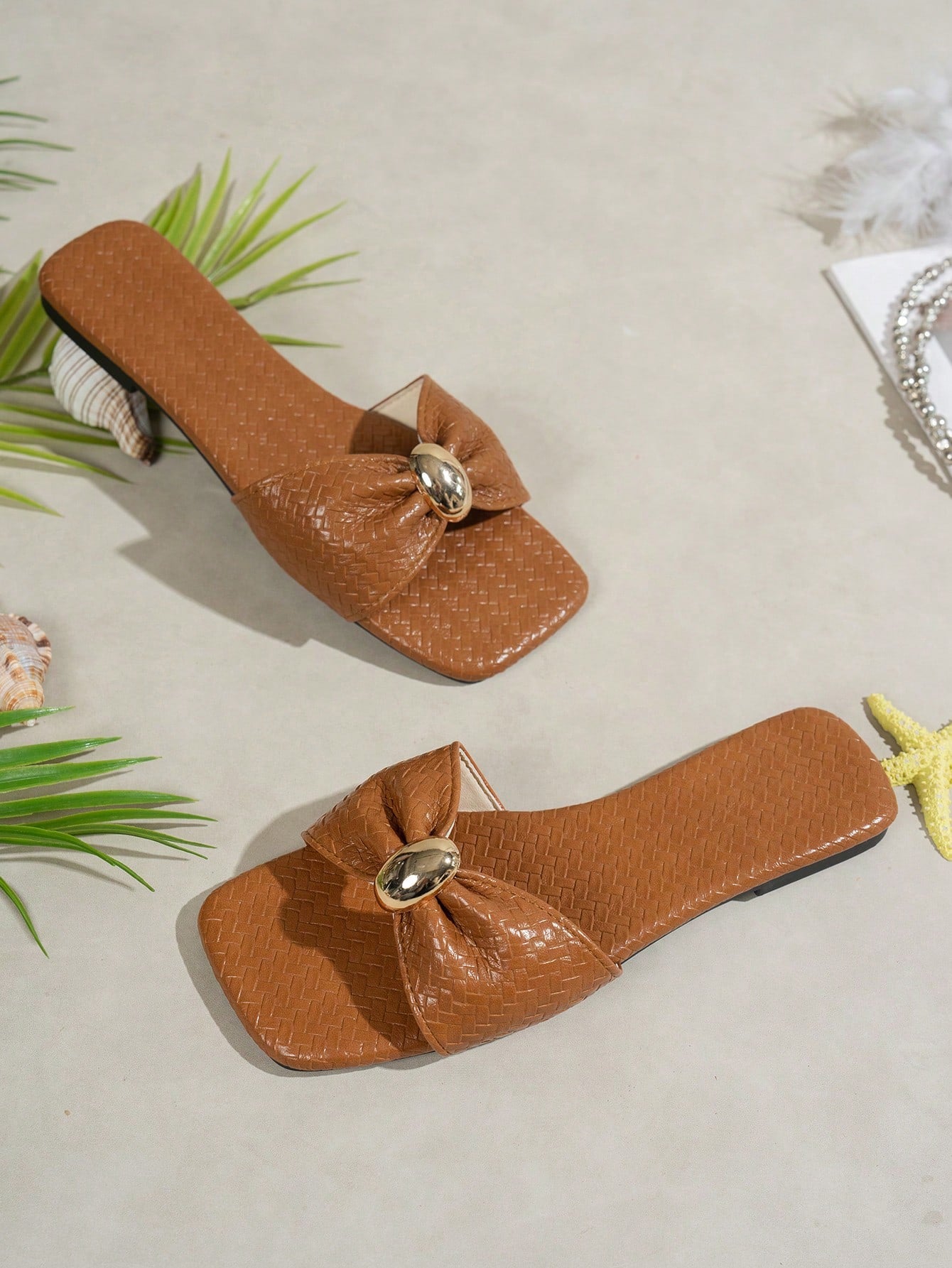 Women's ginger woven flat slide sandals with open toe, bow knot detail, and metal decor in a minimalist beach style.