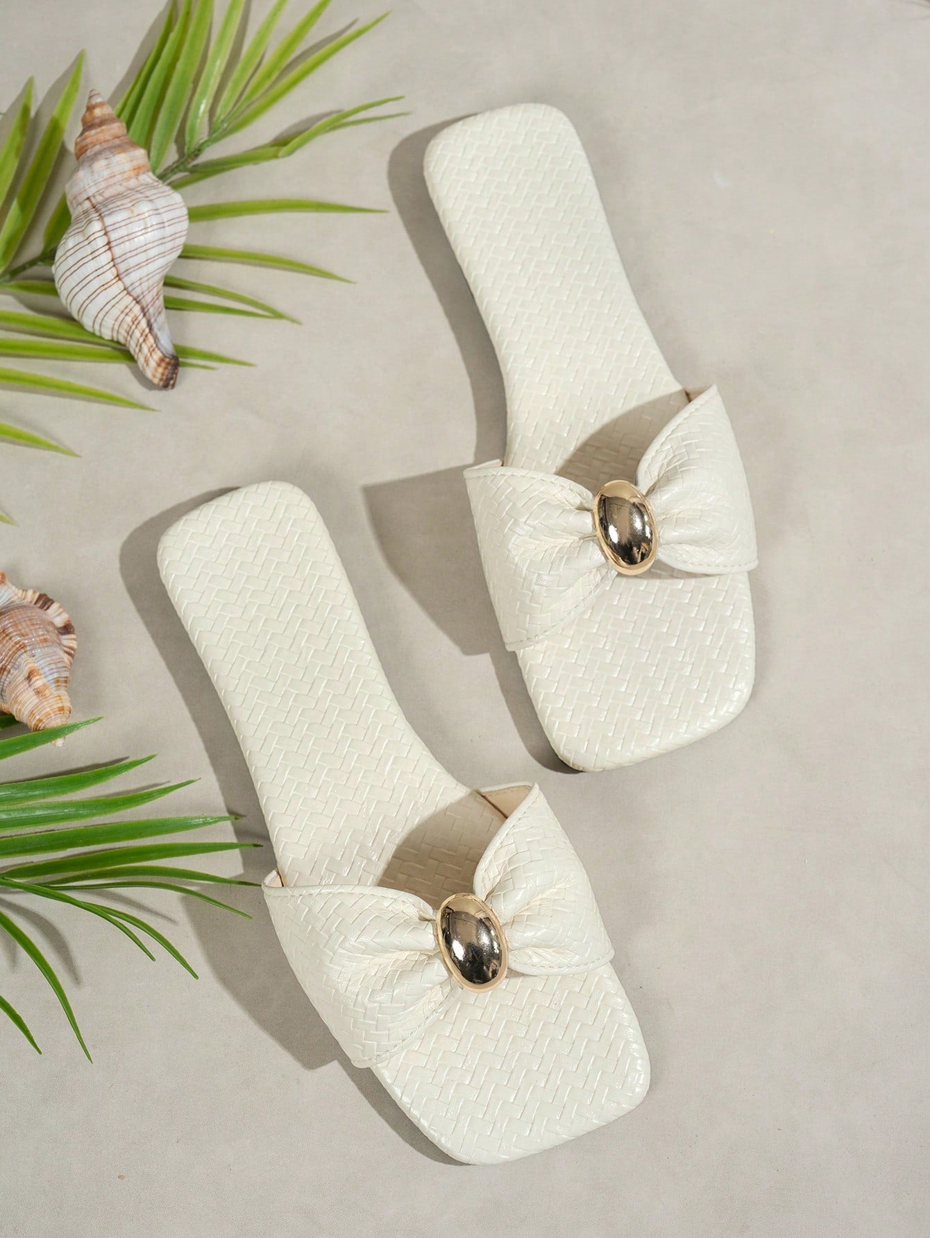 Women's ginger woven flat slide sandals with open toe, bow knot detail, and metal decor in a minimalist beach style.