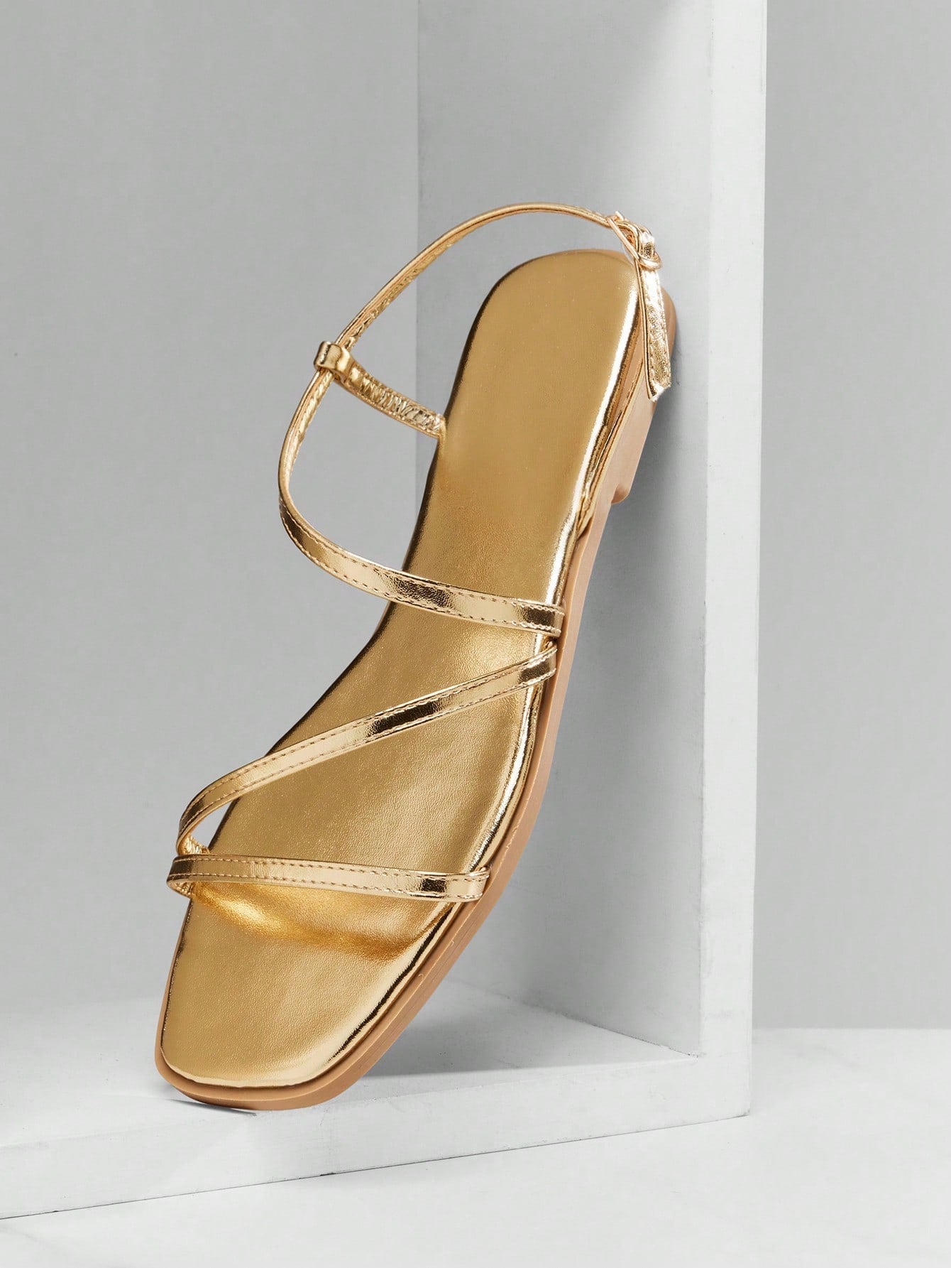 Women's flat open-toe sandals featuring a buckle detail and PU leather construction with a flat sole.