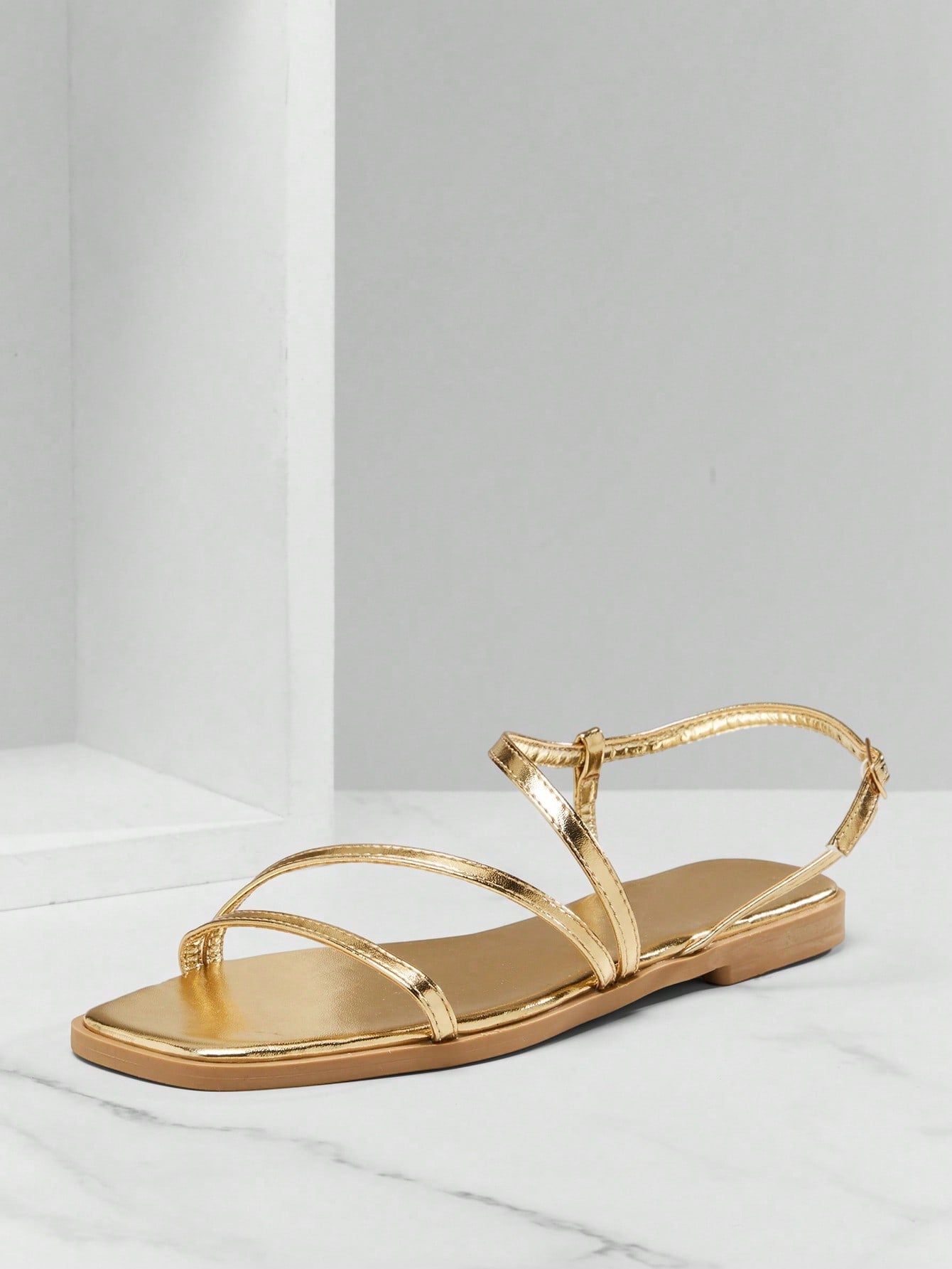 Women's flat open-toe sandals featuring a buckle detail and PU leather construction with a flat sole.
