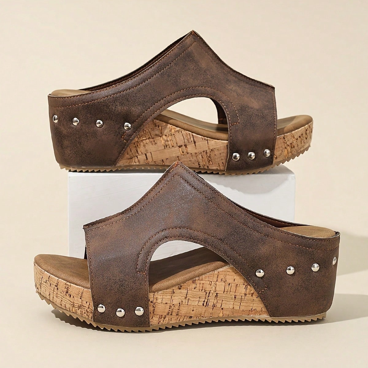Women's plain slip-on slippers with a round toe, platform sole, and studded details, designed for casual daily wear and vacation outfits.