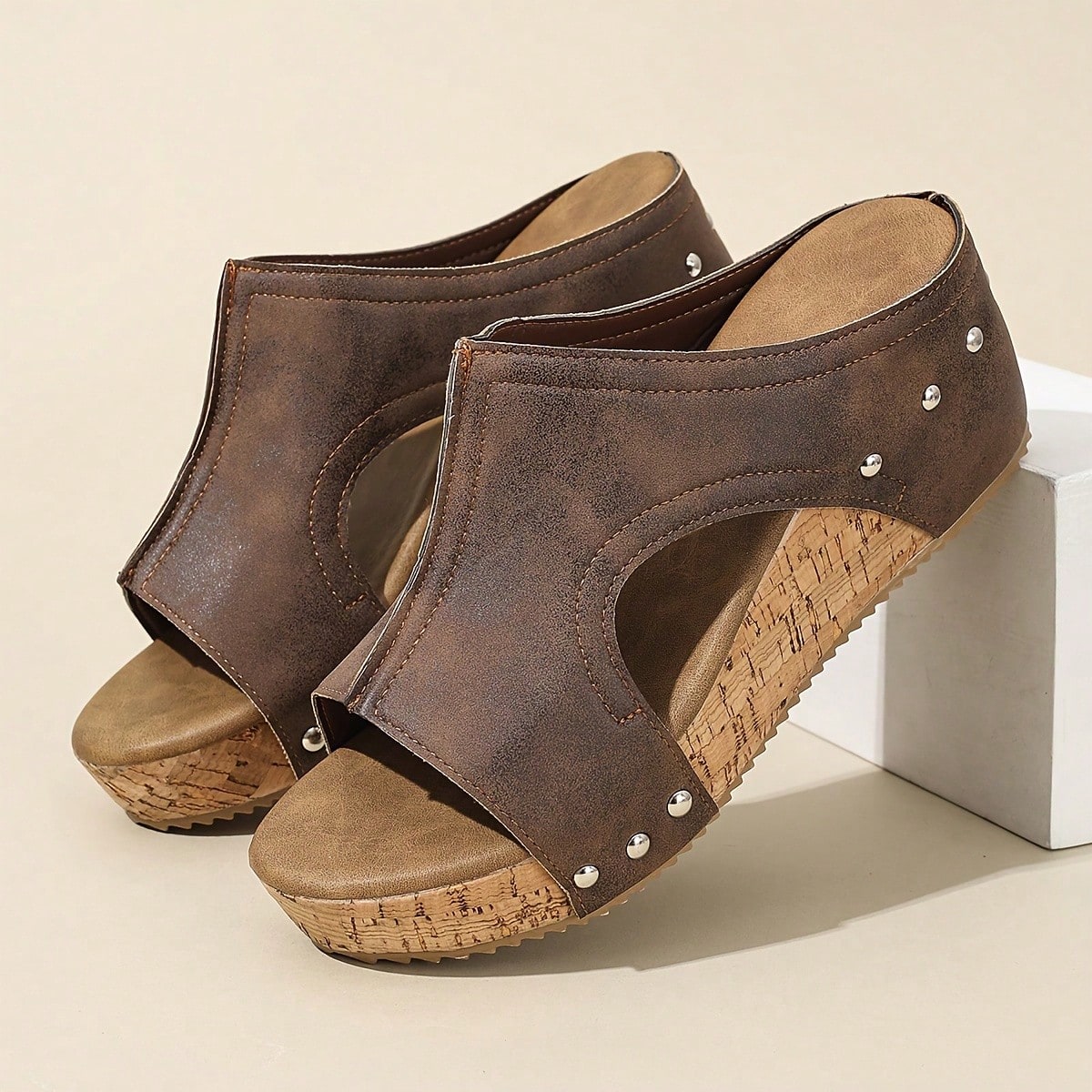 Women's plain slip-on slippers with a round toe, platform sole, and studded details, designed for casual daily wear and vacation outfits.