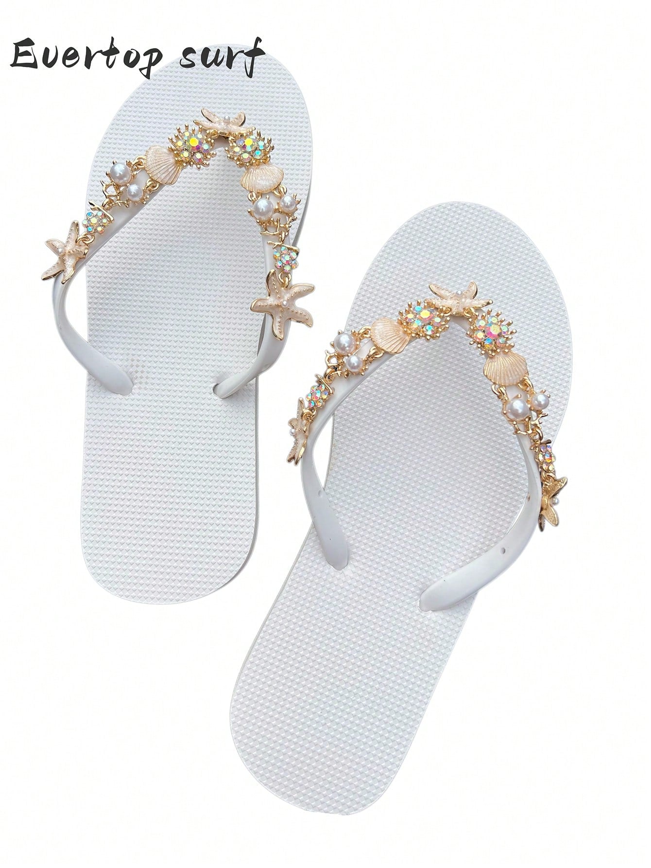 Women’s fashion flip flops with thong strap, beaded shell chain decoration, and removable decor chain detail, designed with a soft flat sole for beach and vacation use.