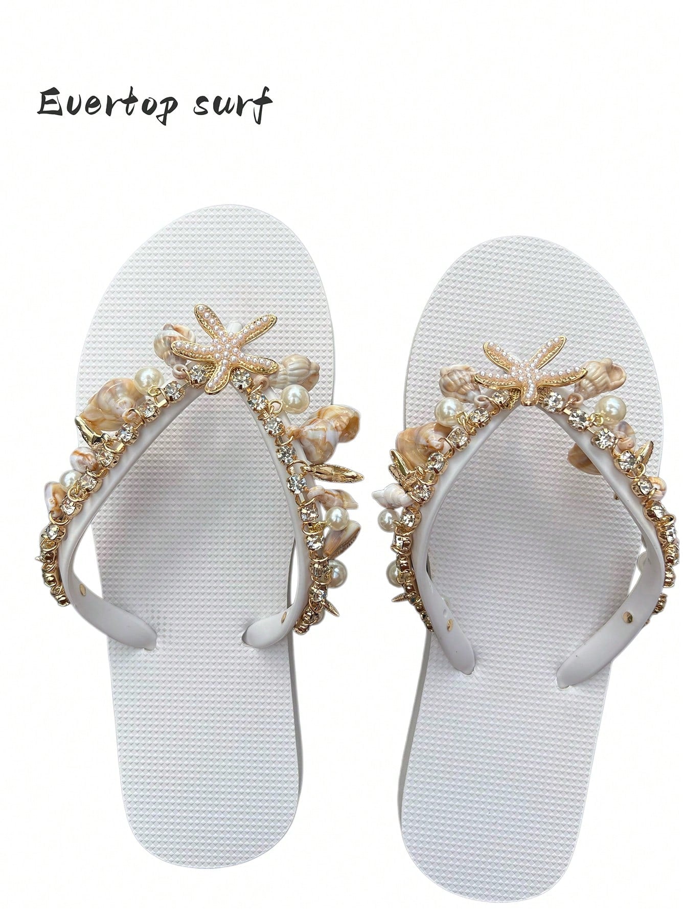 Women’s fashion flip flops with thong strap, beaded shell chain decoration, and removable decor chain detail, designed with a soft flat sole for beach and vacation use.