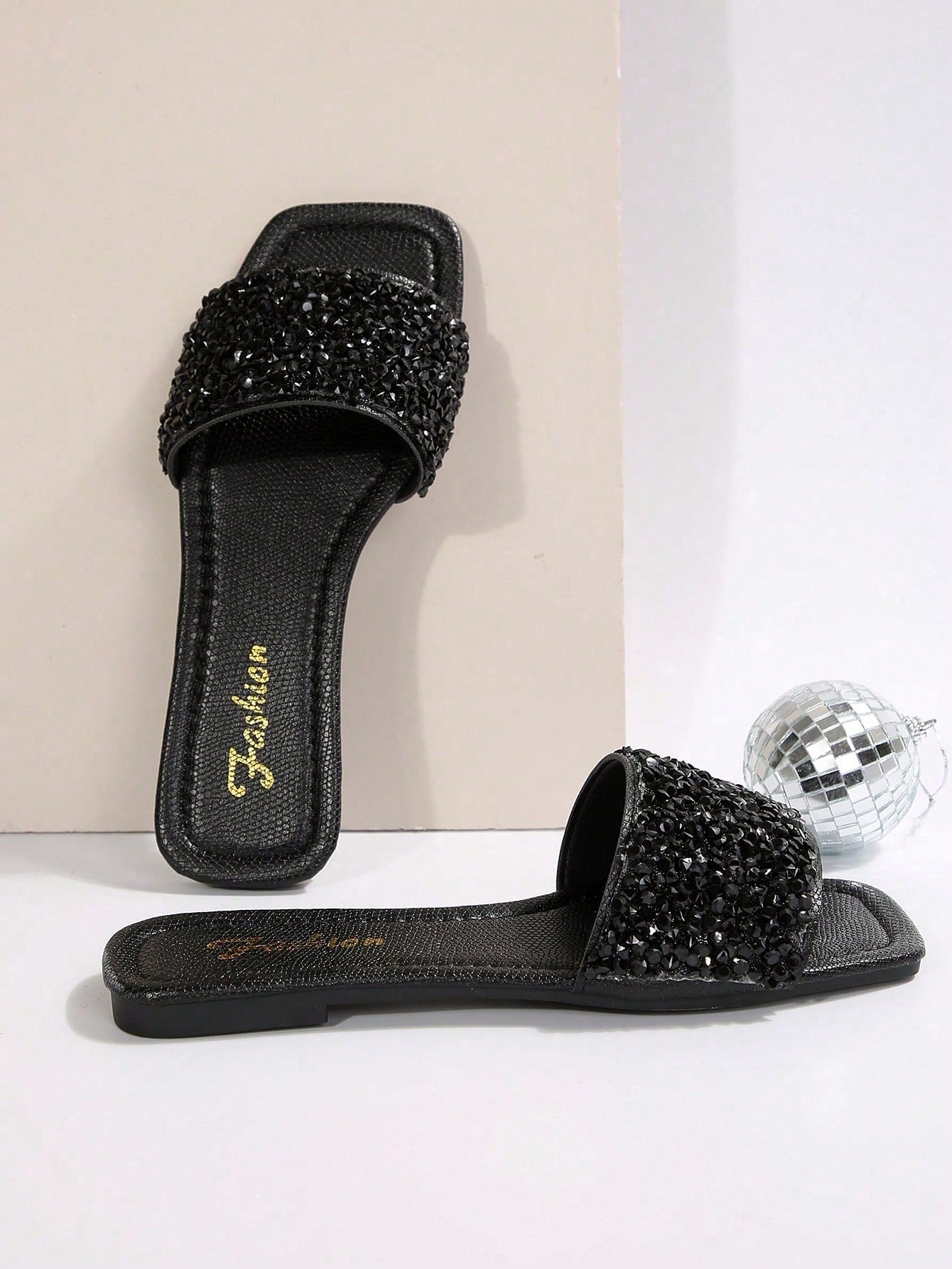 Black plus size women's slip-on flat slide sandals with square open toe, soft non-slip sole, and pearl rhinestone embellishments.
