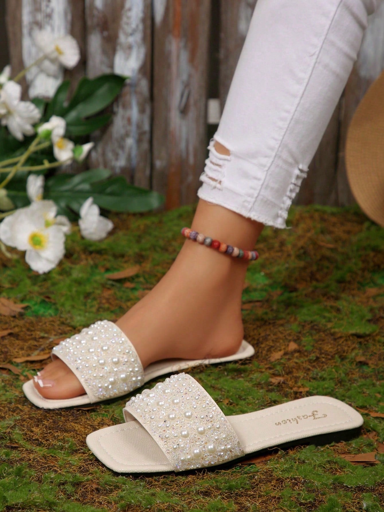 Black plus size women's slip-on flat slide sandals with square open toe, soft non-slip sole, and pearl rhinestone embellishments.