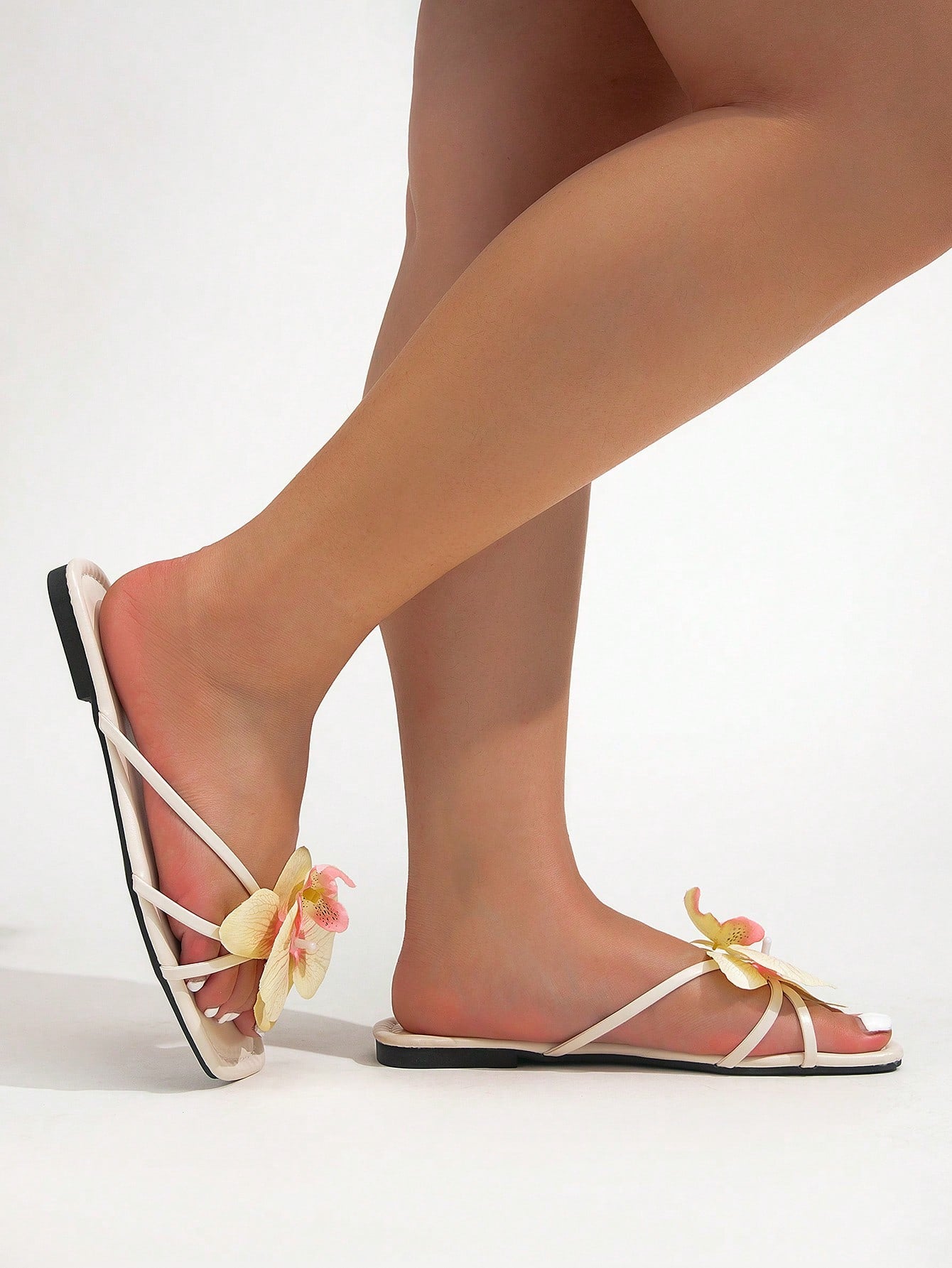 Wide fit women's beige flat thong sandals with butterfly orchid appliqué decor and open toe, suitable for beach, vacation, home, and casual everyday wear.