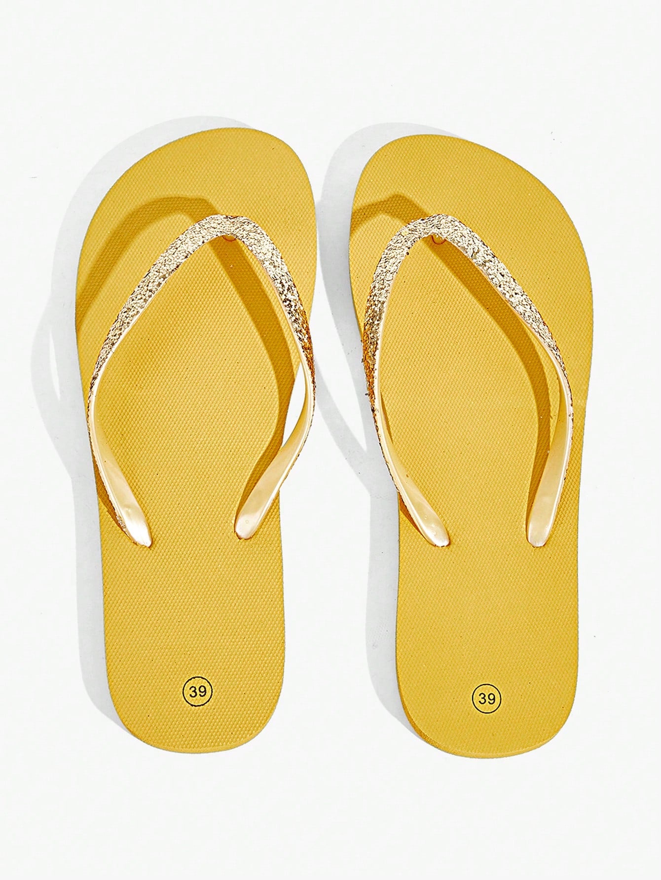 Pair of women’s apricot flat flip-flops with a glitter upper and plain design, suitable for beach, outdoor, home, and vacation wear.