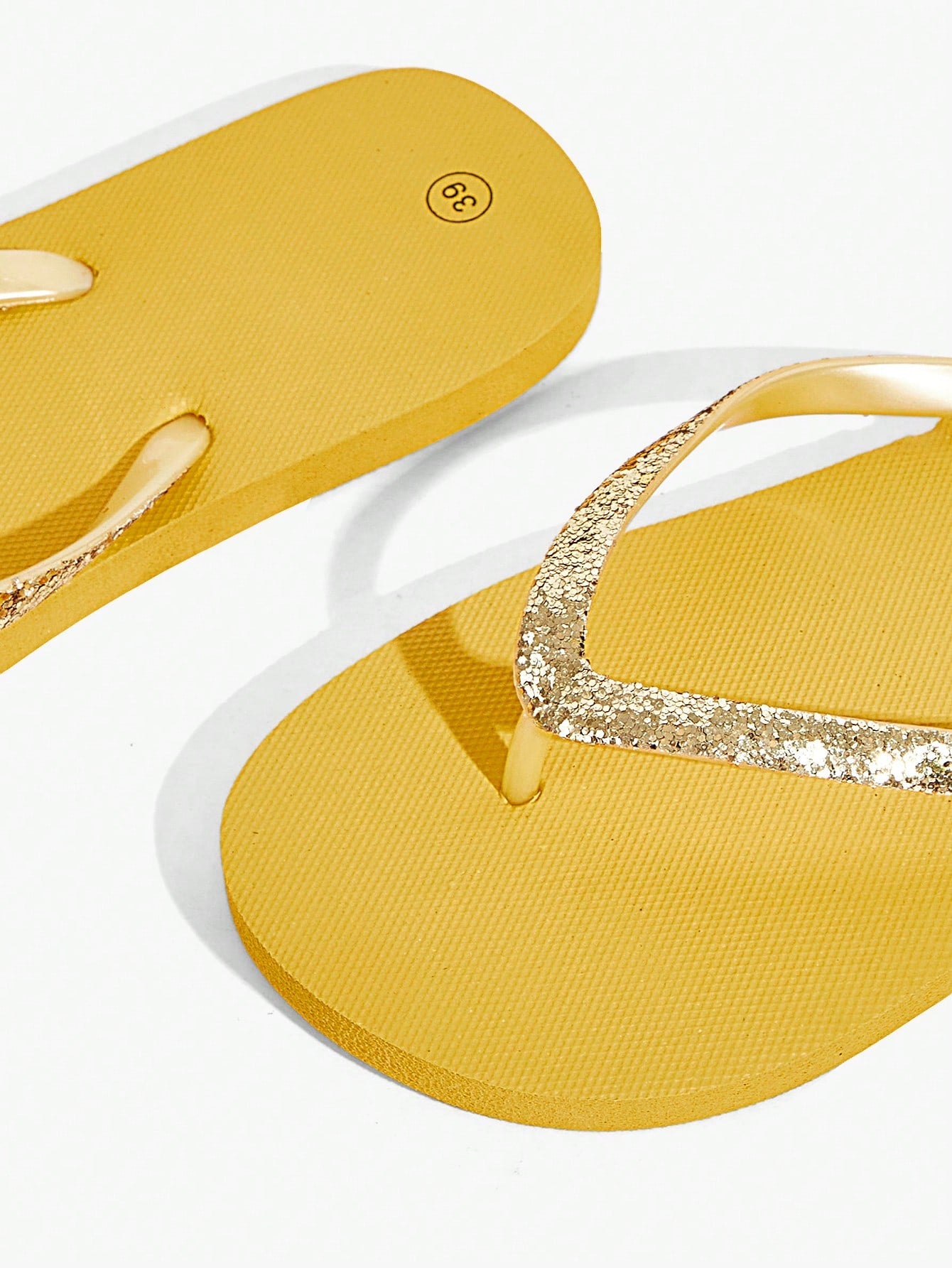 Pair of women’s apricot flat flip-flops with a glitter upper and plain design, suitable for beach, outdoor, home, and vacation wear.