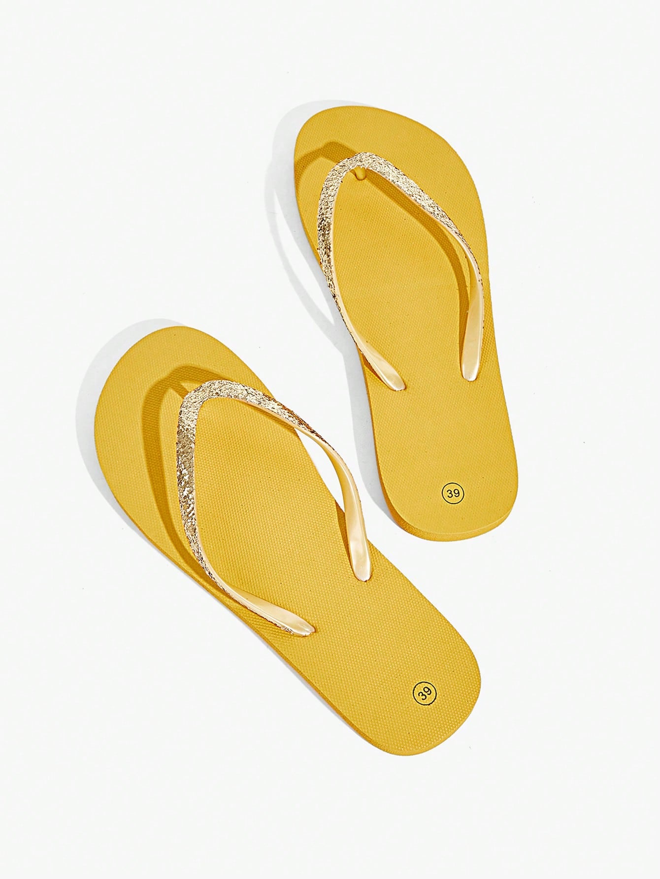 Pair of women’s apricot flat flip-flops with a glitter upper and plain design, suitable for beach, outdoor, home, and vacation wear.