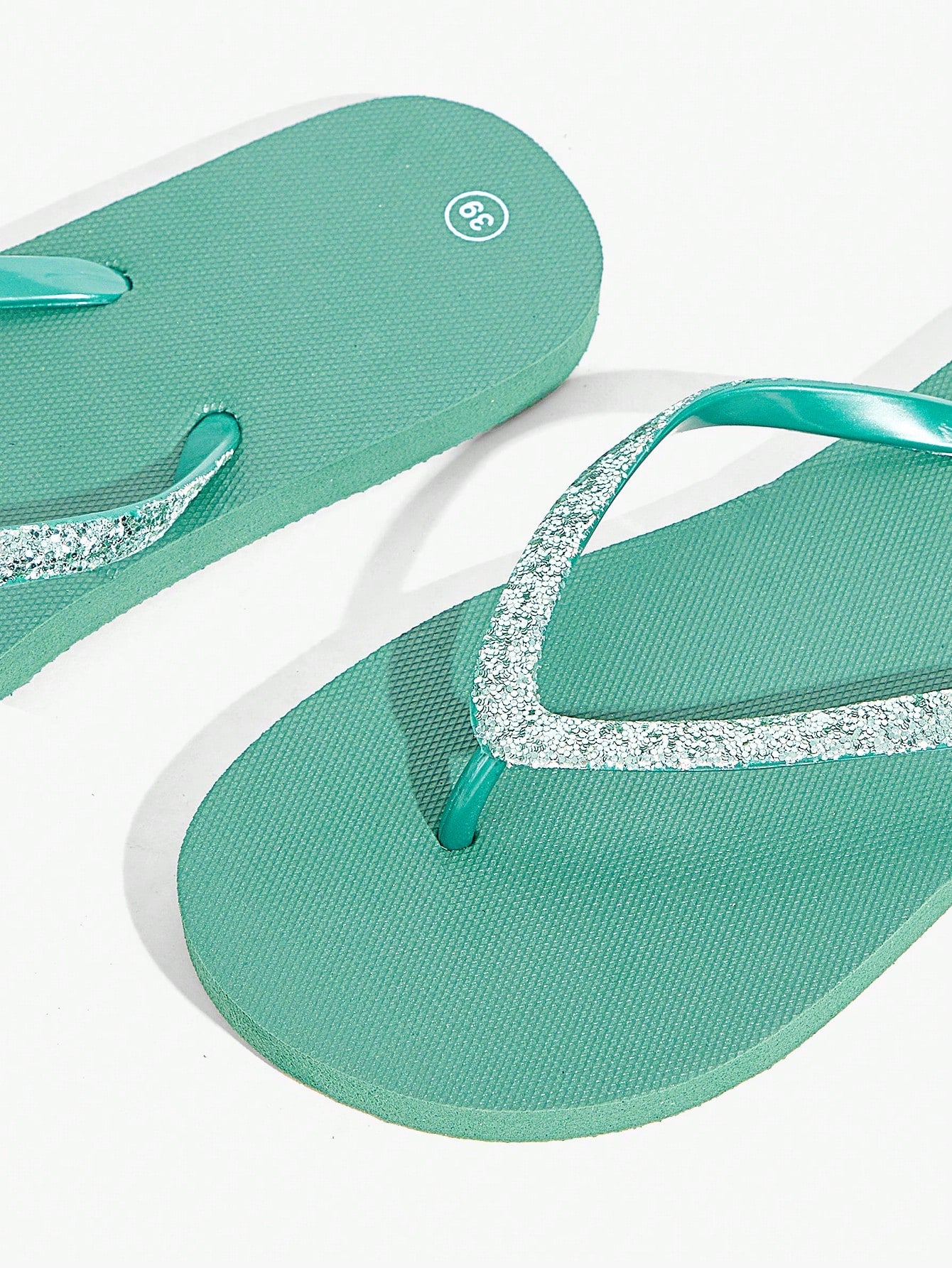 Pair of women’s apricot flat flip-flops with a glitter upper and plain design, suitable for beach, outdoor, home, and vacation wear.