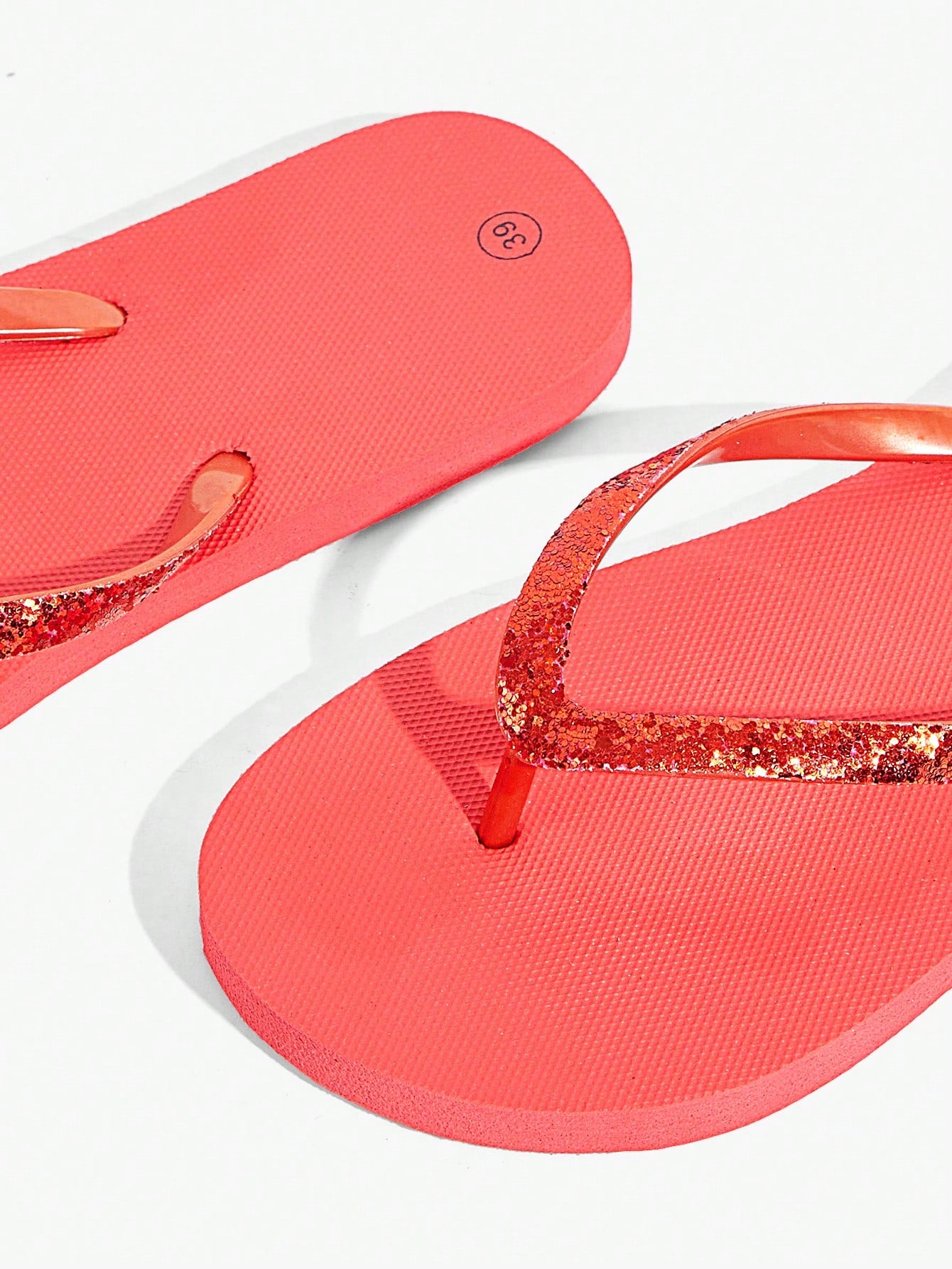 Pair of women’s apricot flat flip-flops with a glitter upper and plain design, suitable for beach, outdoor, home, and vacation wear.