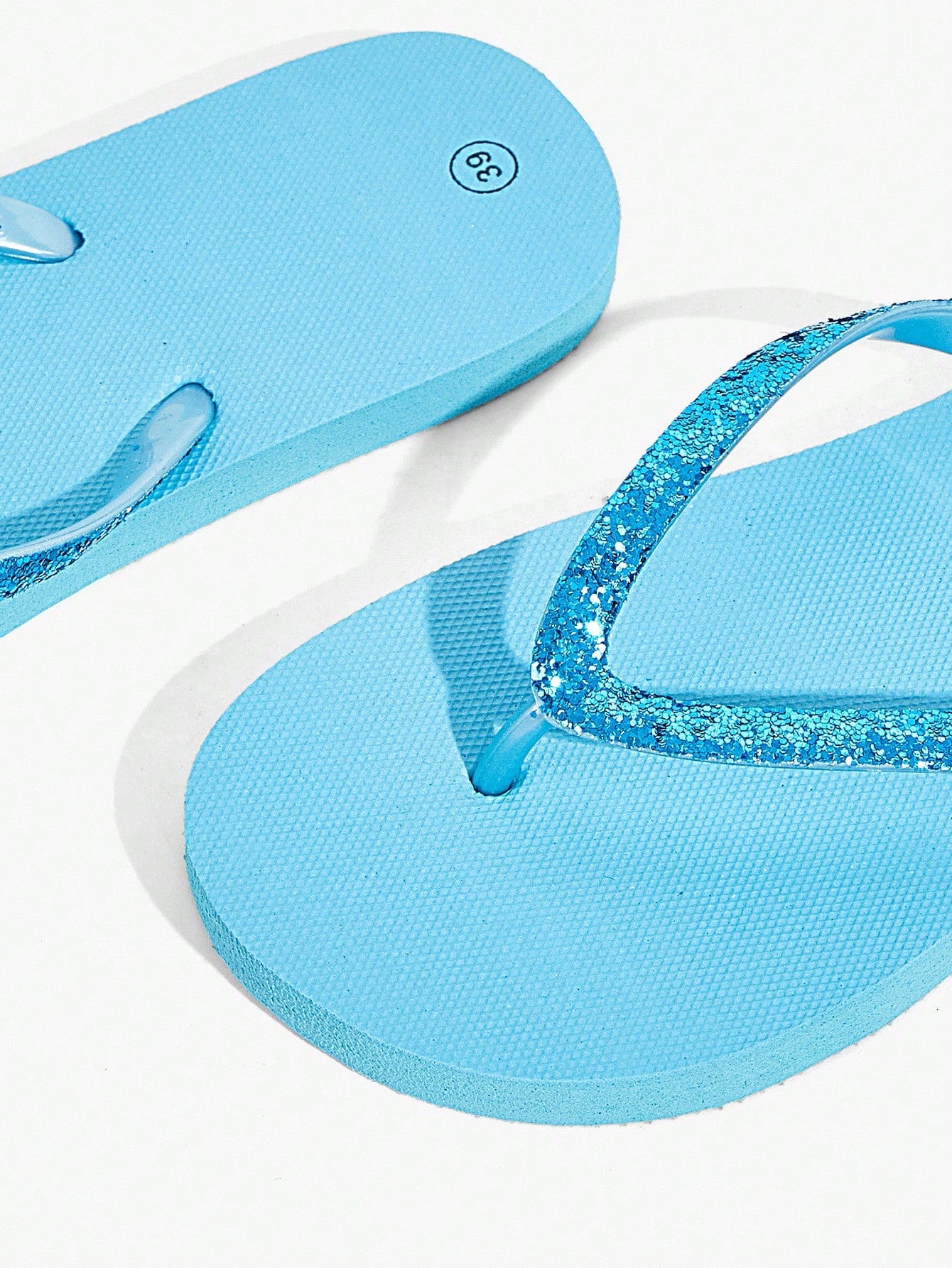 Pair of women’s apricot flat flip-flops with a glitter upper and plain design, suitable for beach, outdoor, home, and vacation wear.