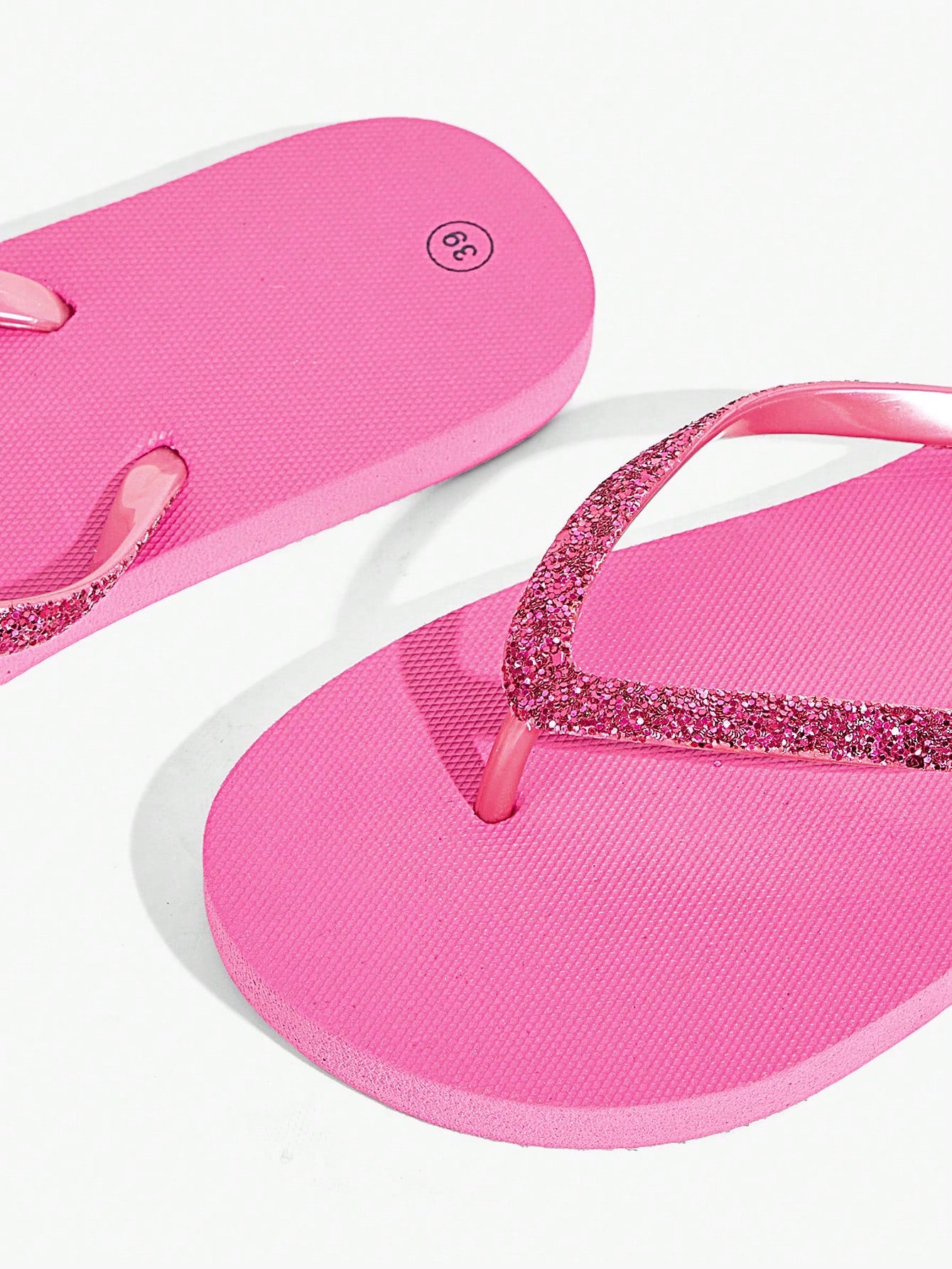 Pair of women’s apricot flat flip-flops with a glitter upper and plain design, suitable for beach, outdoor, home, and vacation wear.