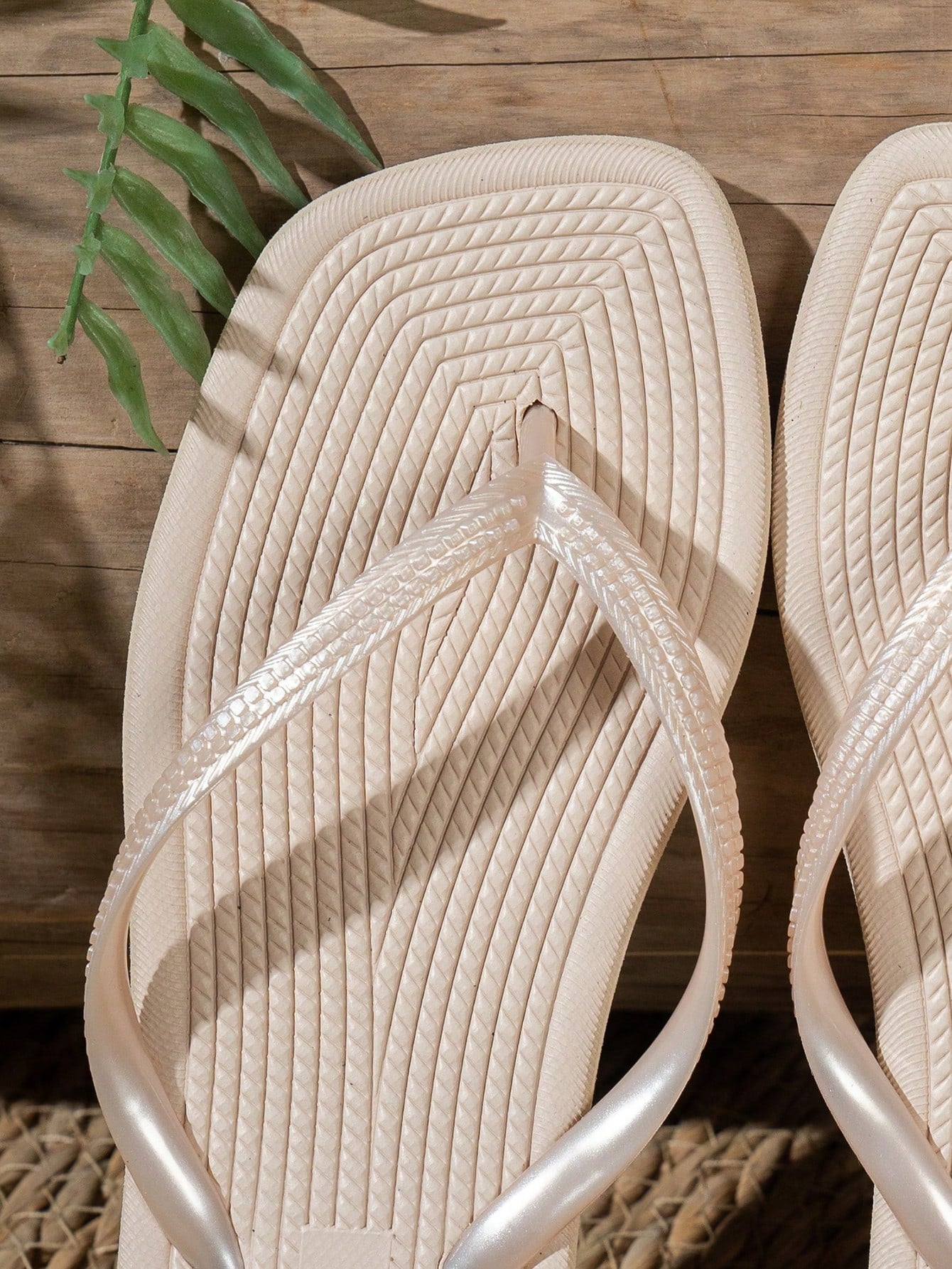 Women's solid color flip flops with open-toe design, flat sole, and cut-out details, suitable for casual indoor or outdoor wear at the beach or pool.