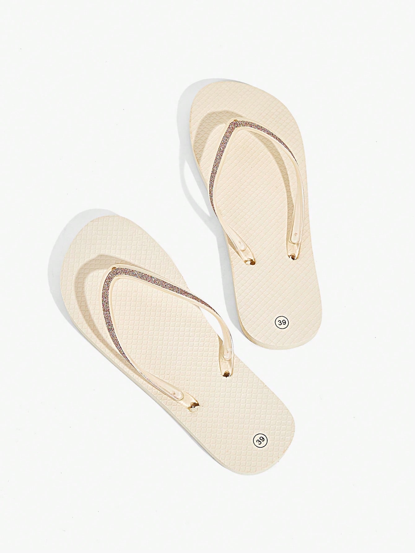 Pair of women’s apricot flat flip-flops with a glitter upper and plain design, suitable for beach, outdoor, home, and vacation wear.