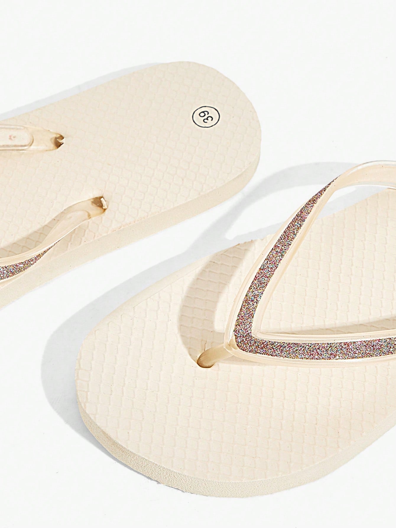 Pair of women’s apricot flat flip-flops with a glitter upper and plain design, suitable for beach, outdoor, home, and vacation wear.
