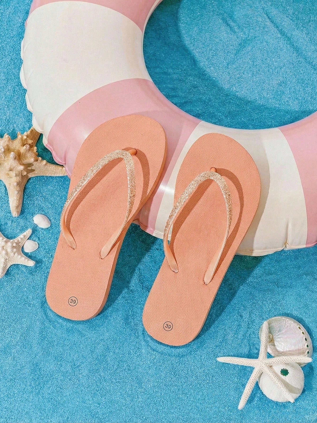 Pair of women’s apricot flat flip-flops with a glitter upper and plain design, suitable for beach, outdoor, home, and vacation wear.