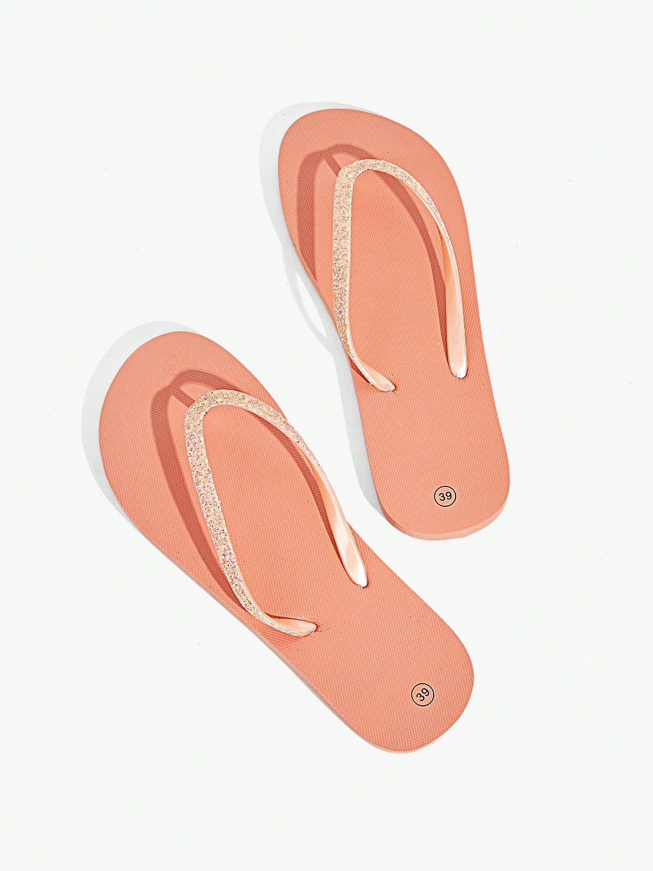 Pair of women’s apricot flat flip-flops with a glitter upper and plain design, suitable for beach, outdoor, home, and vacation wear.